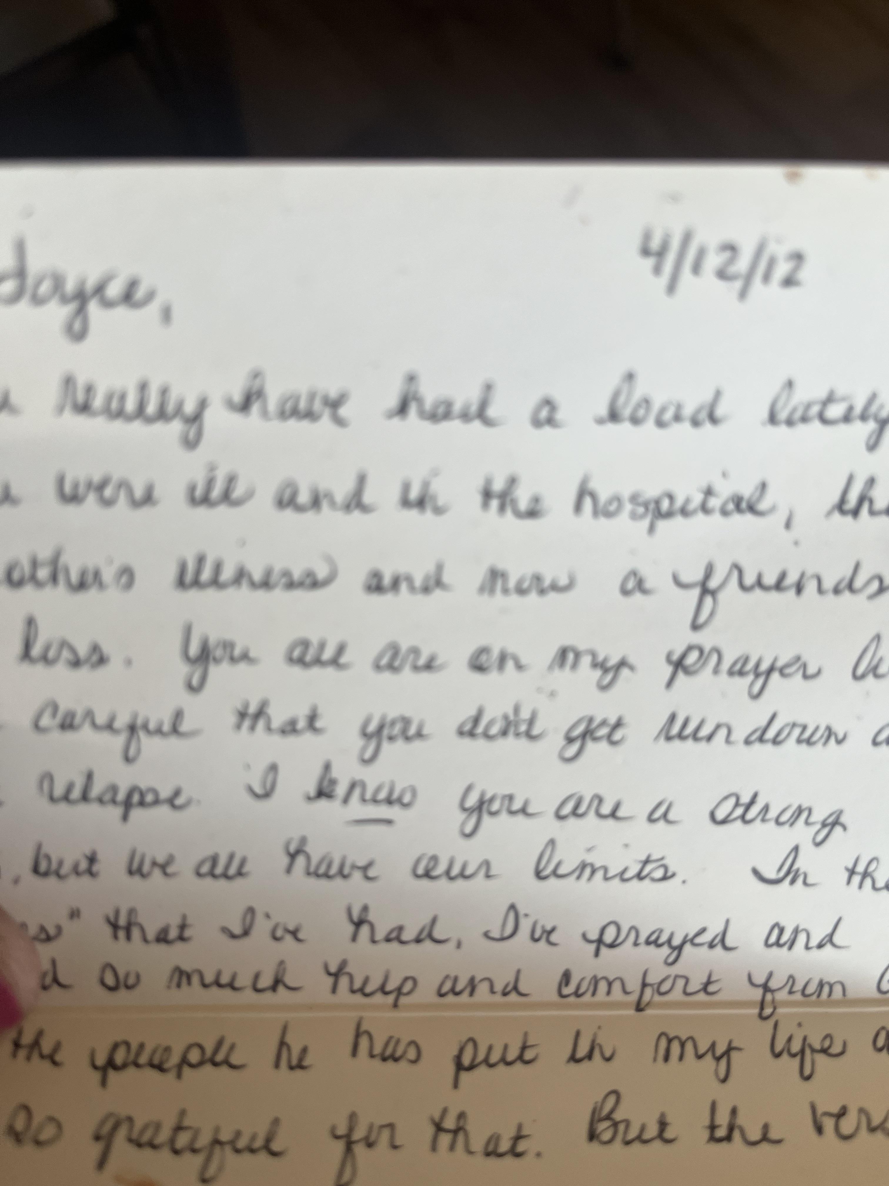 A hand holding a letter