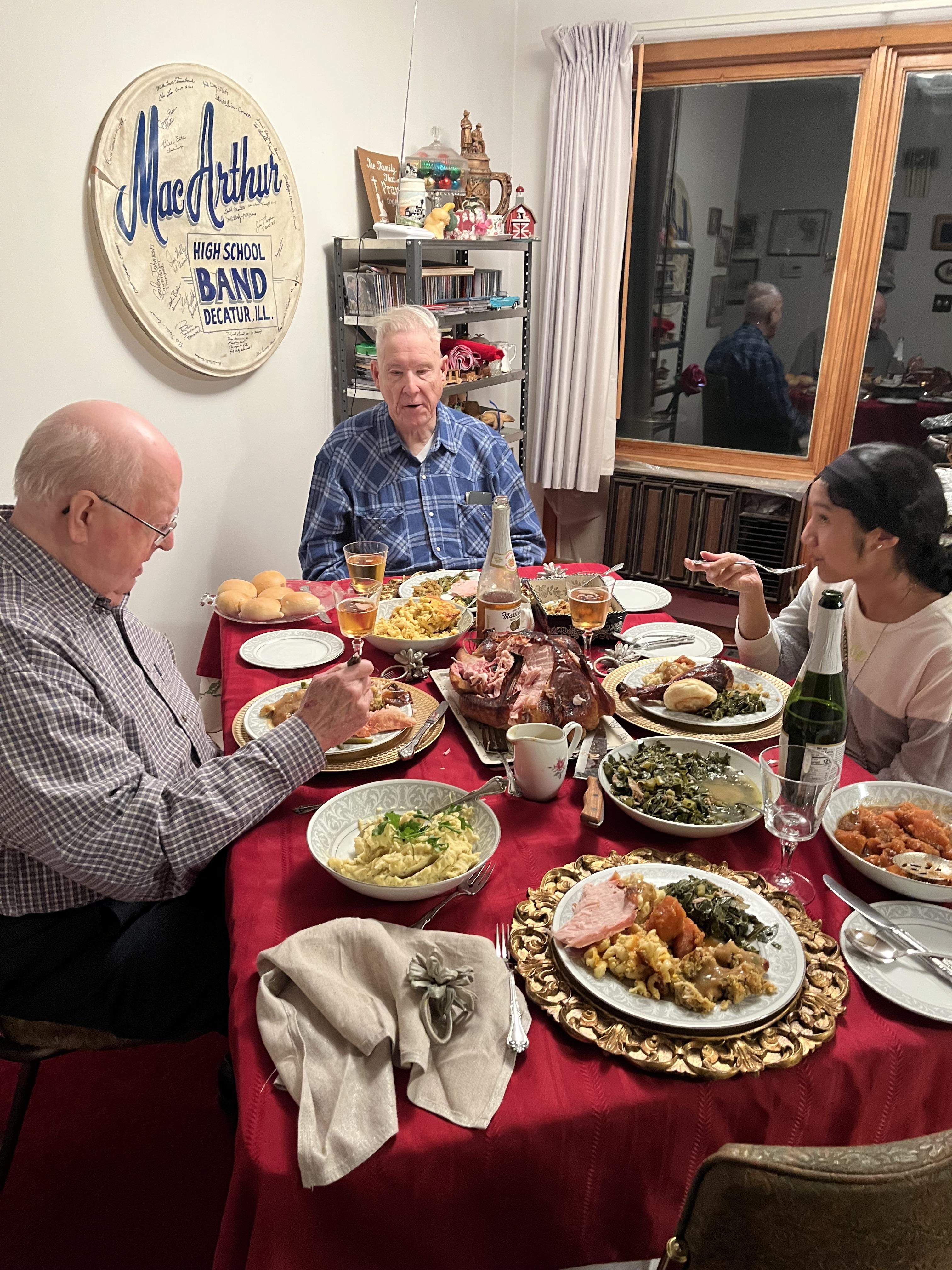 A group of people sitting at a table with food