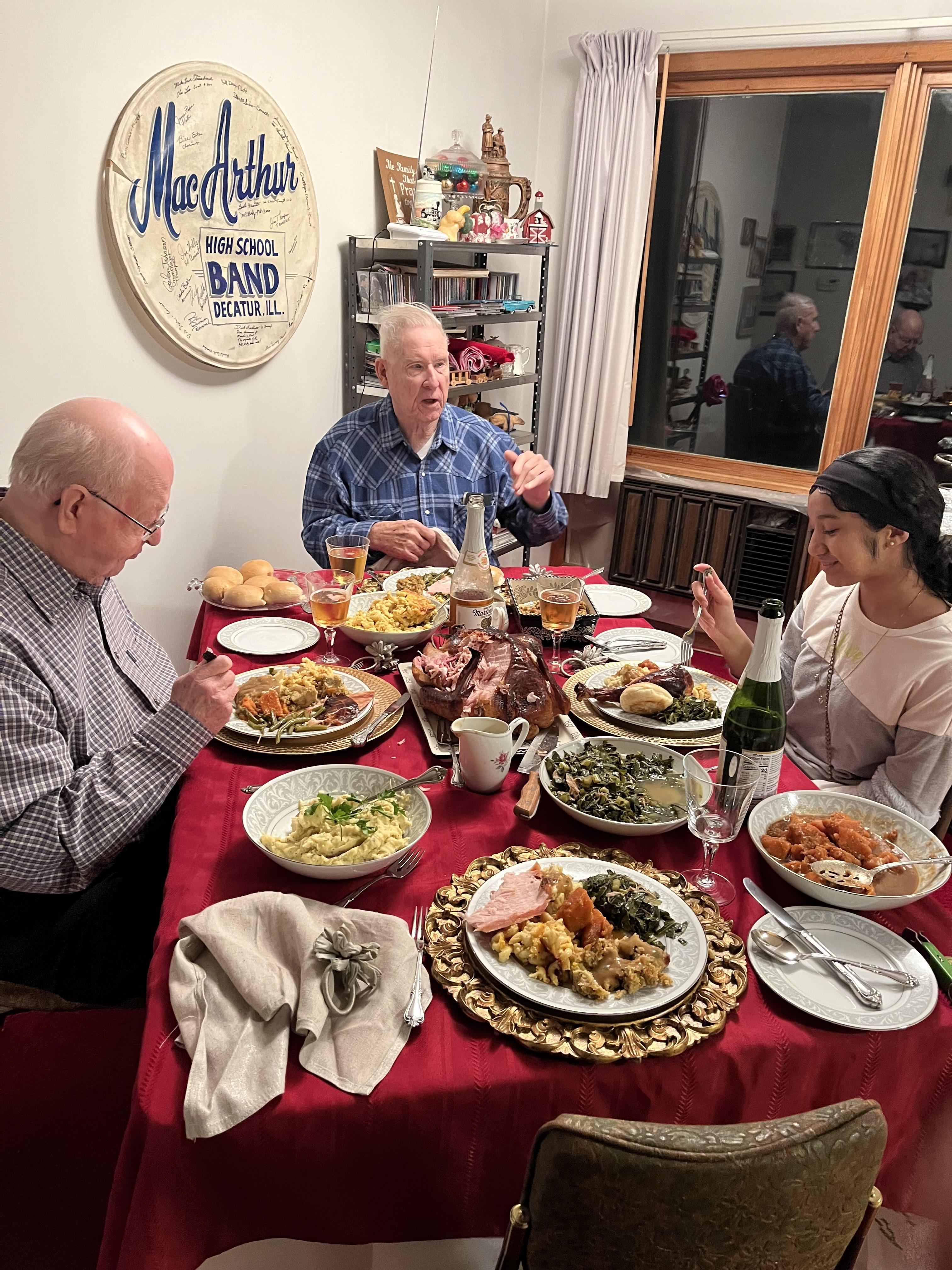 A group of people sitting at a table with food