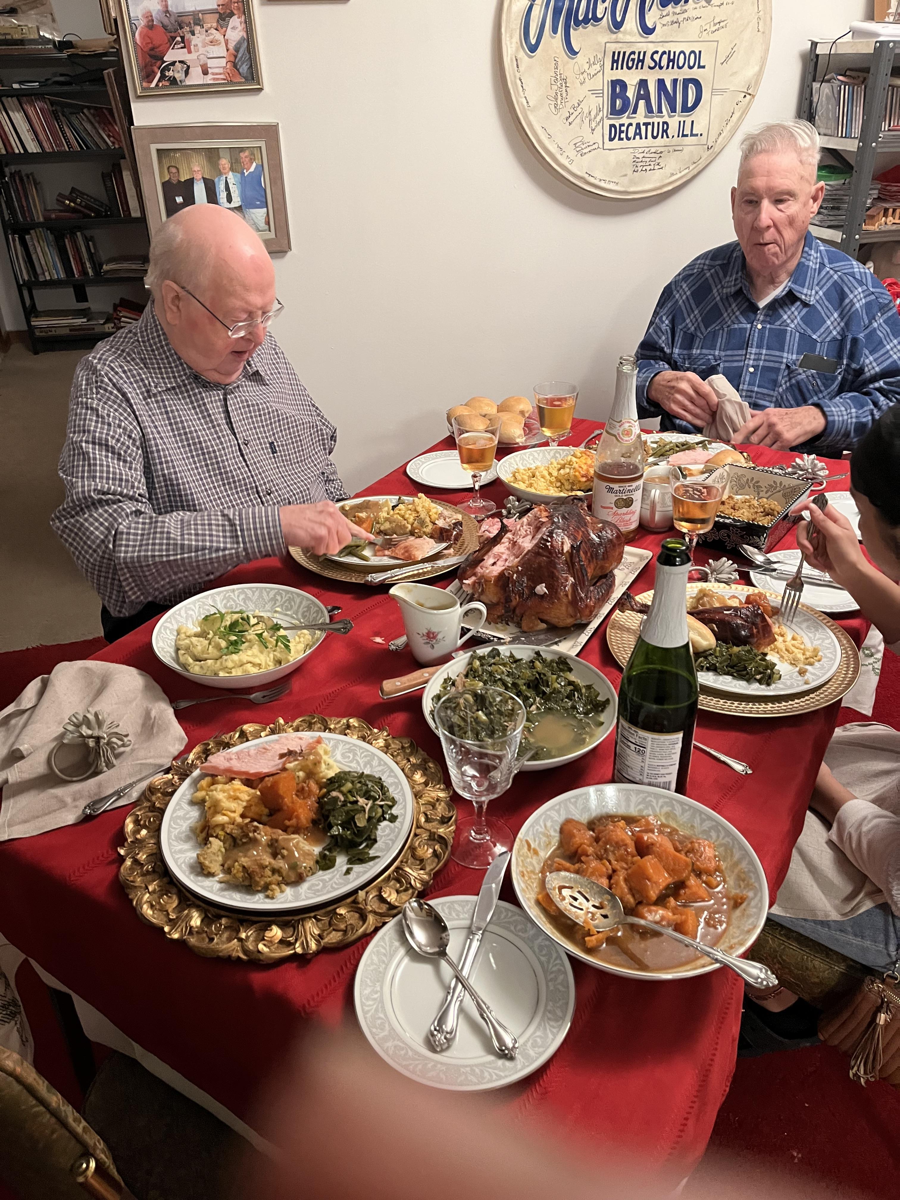 A group of people sitting at a table with food