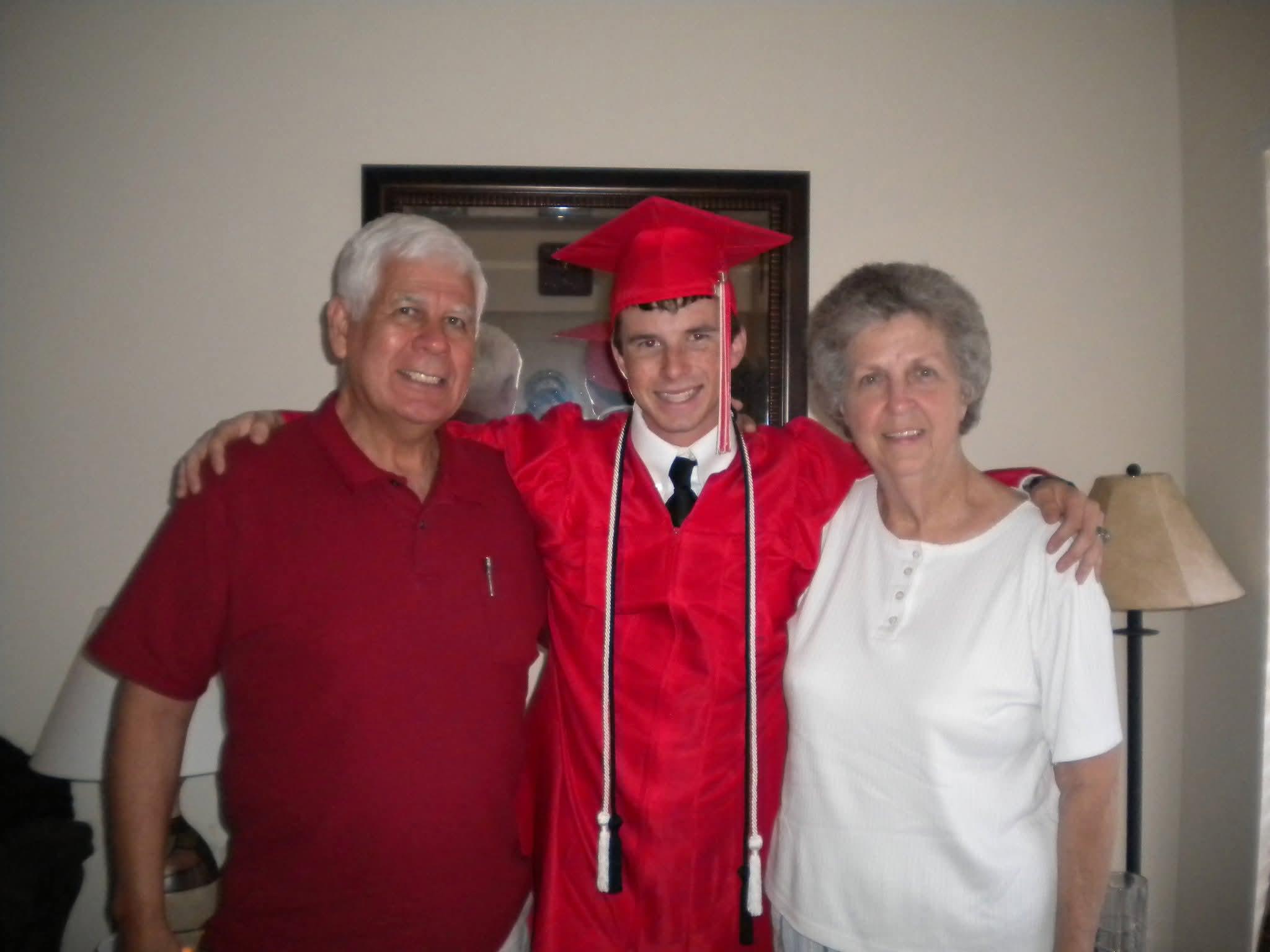 A man in a cap and gown with a man and woman in a room