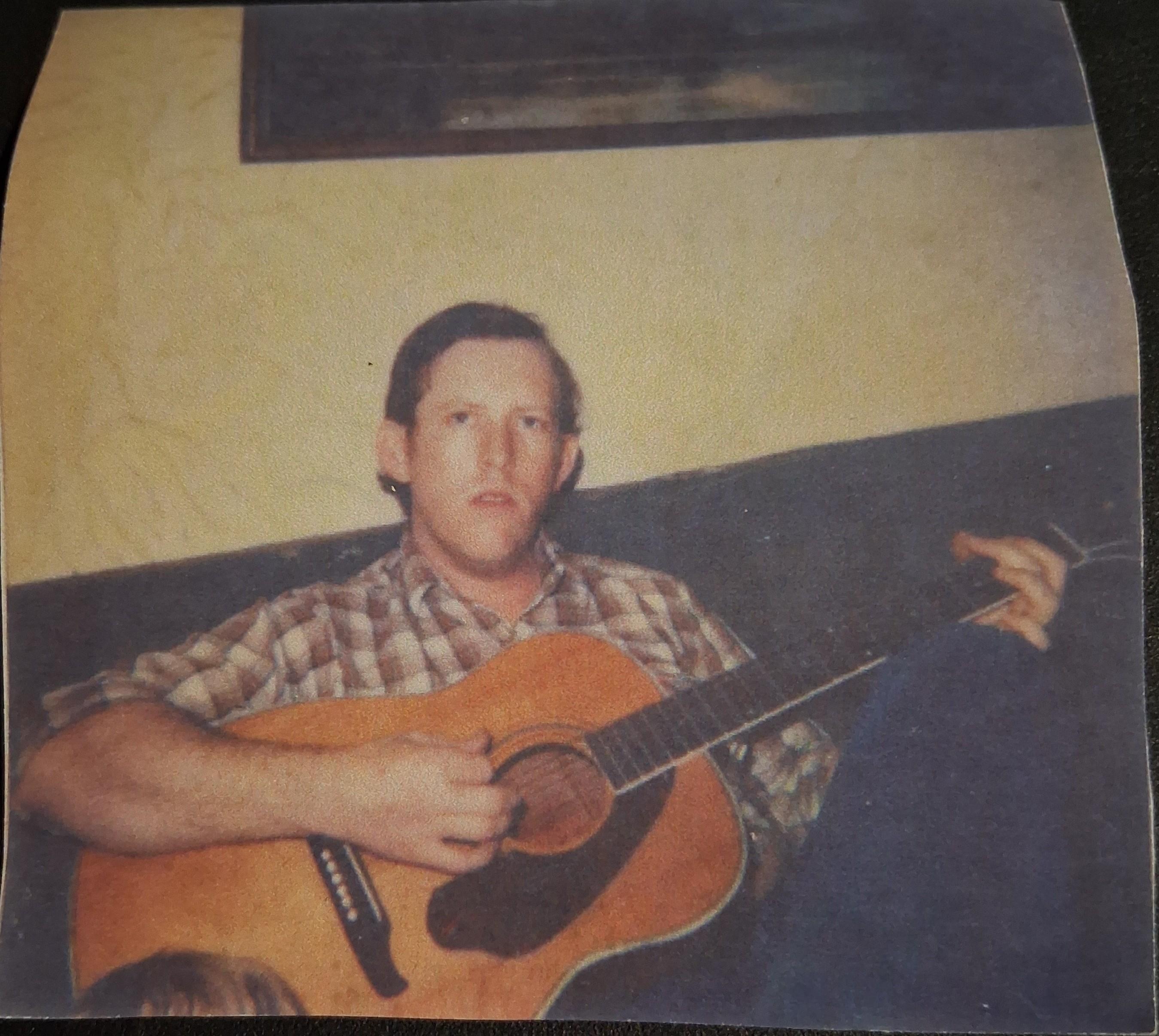 A man holding a guitar