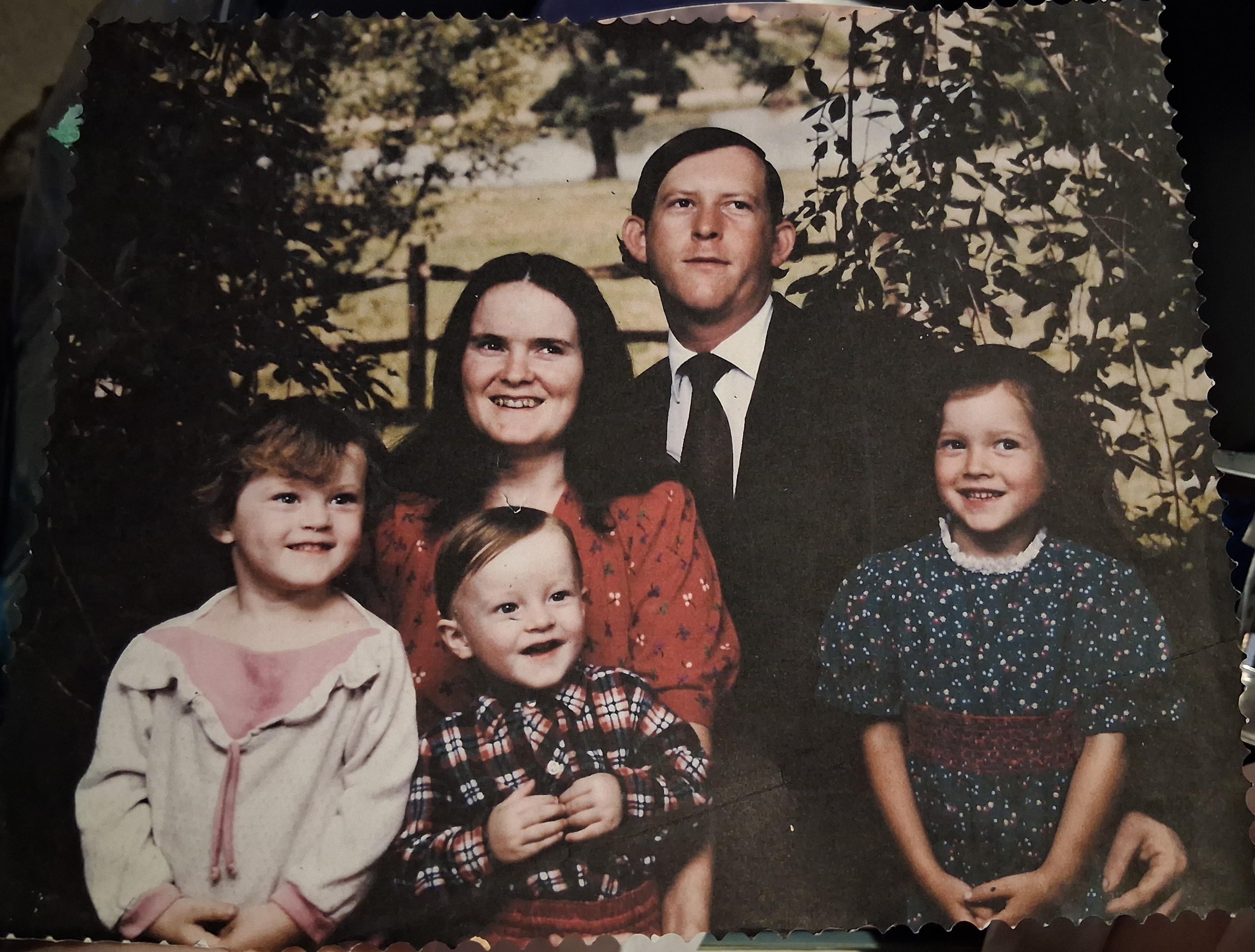 A family photo of a man and woman and children