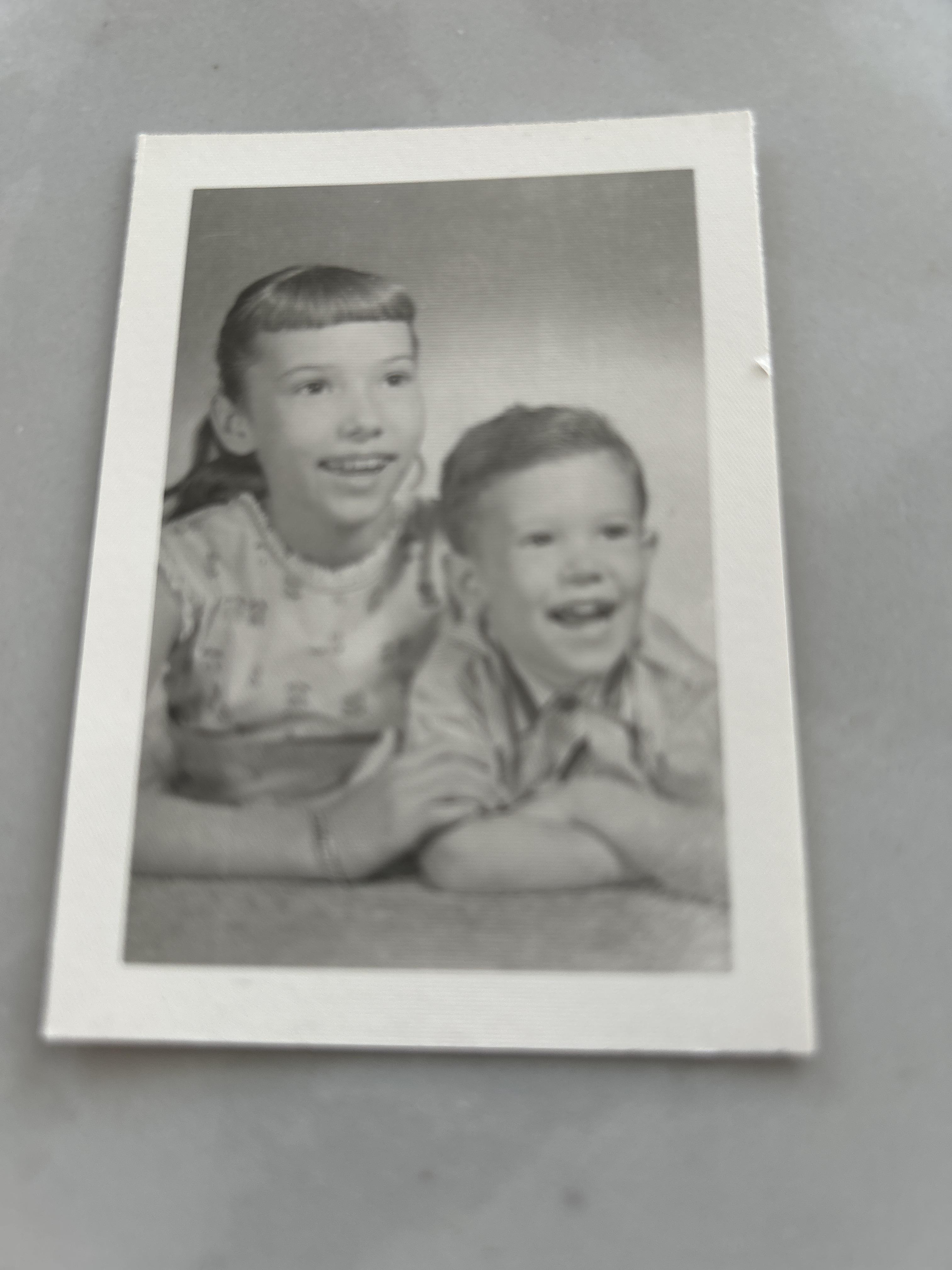 A black and white photo of a boy and girl