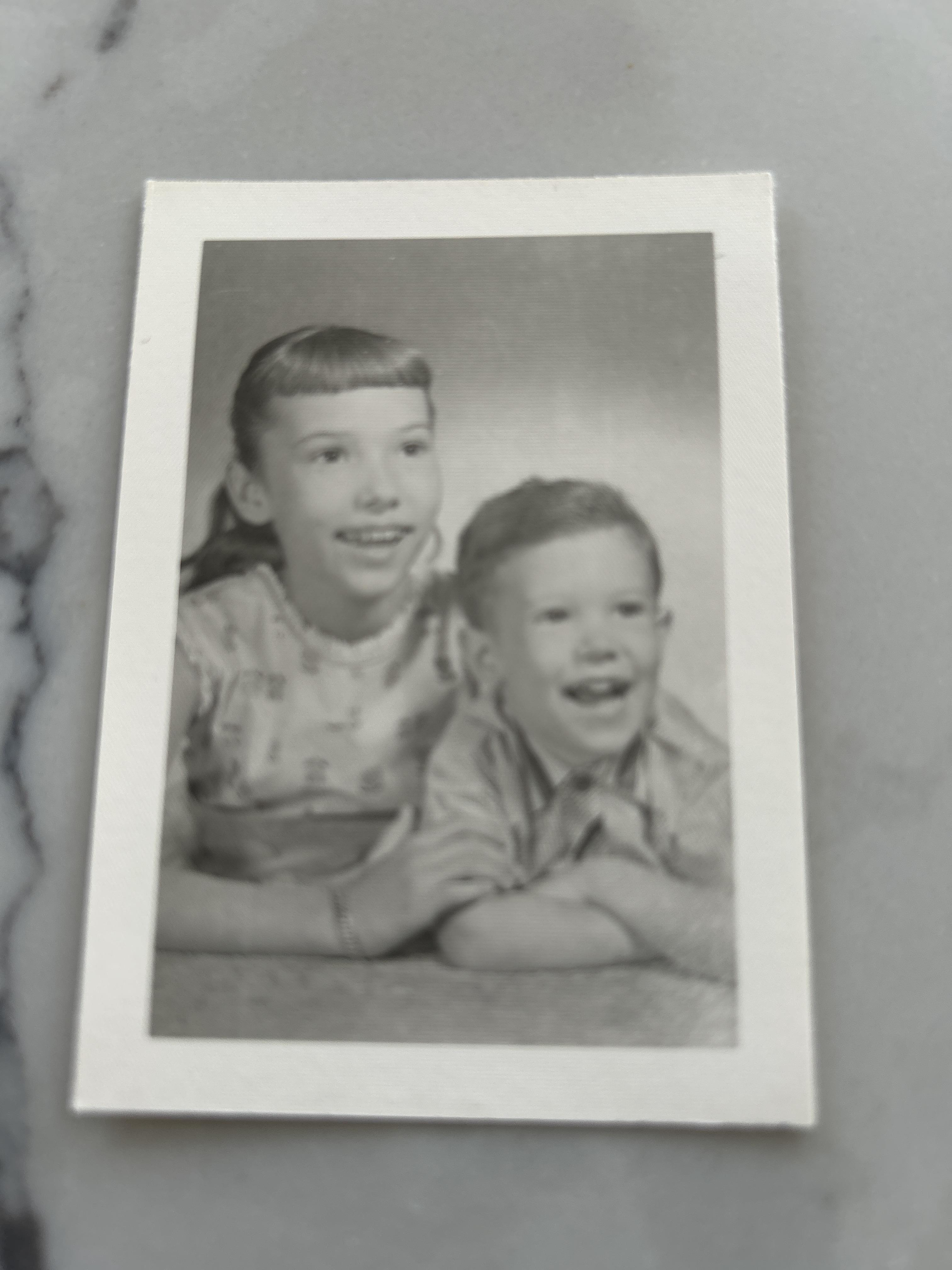 A black and white photo of a boy and girl