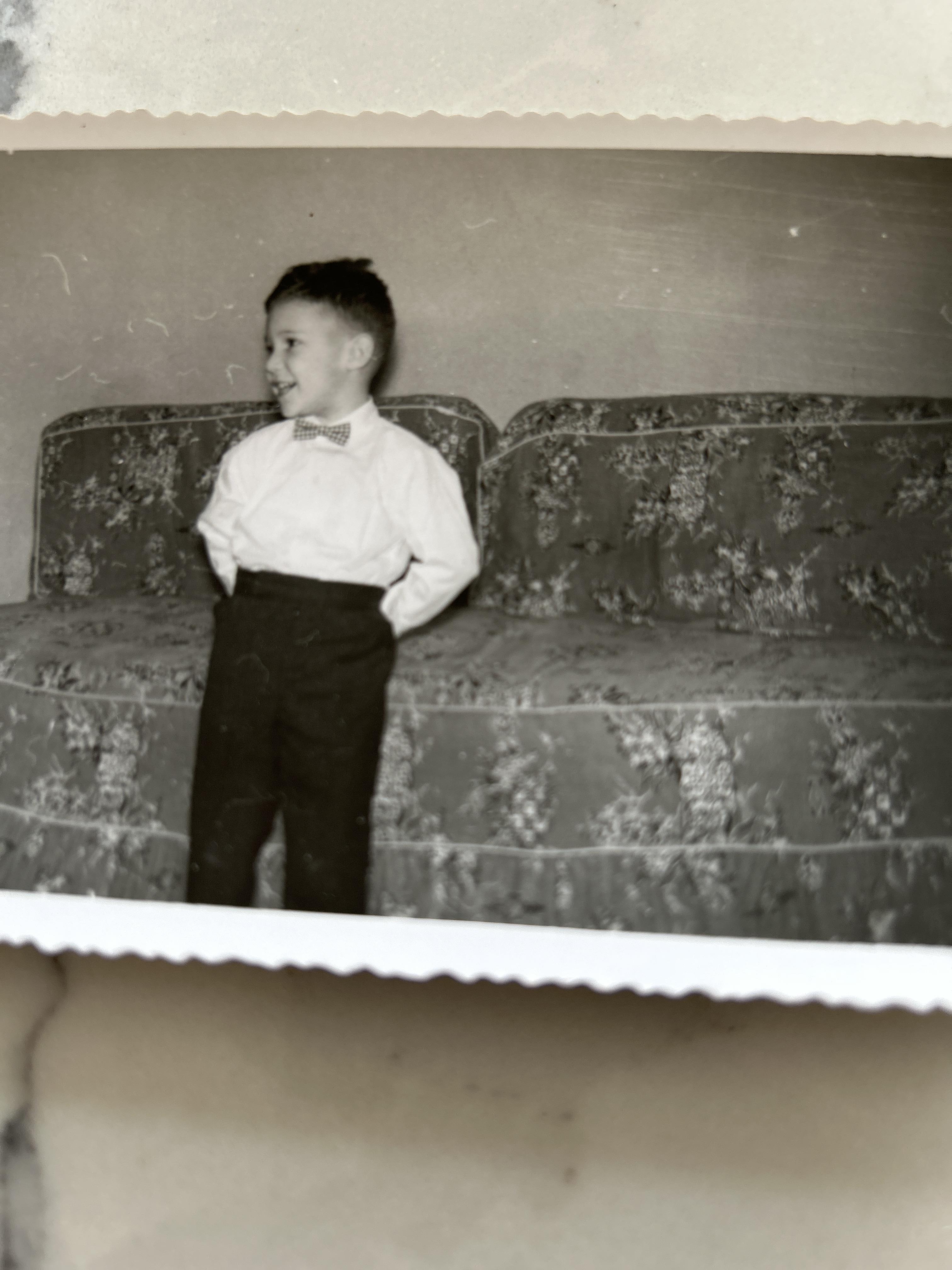 A boy standing on a couch