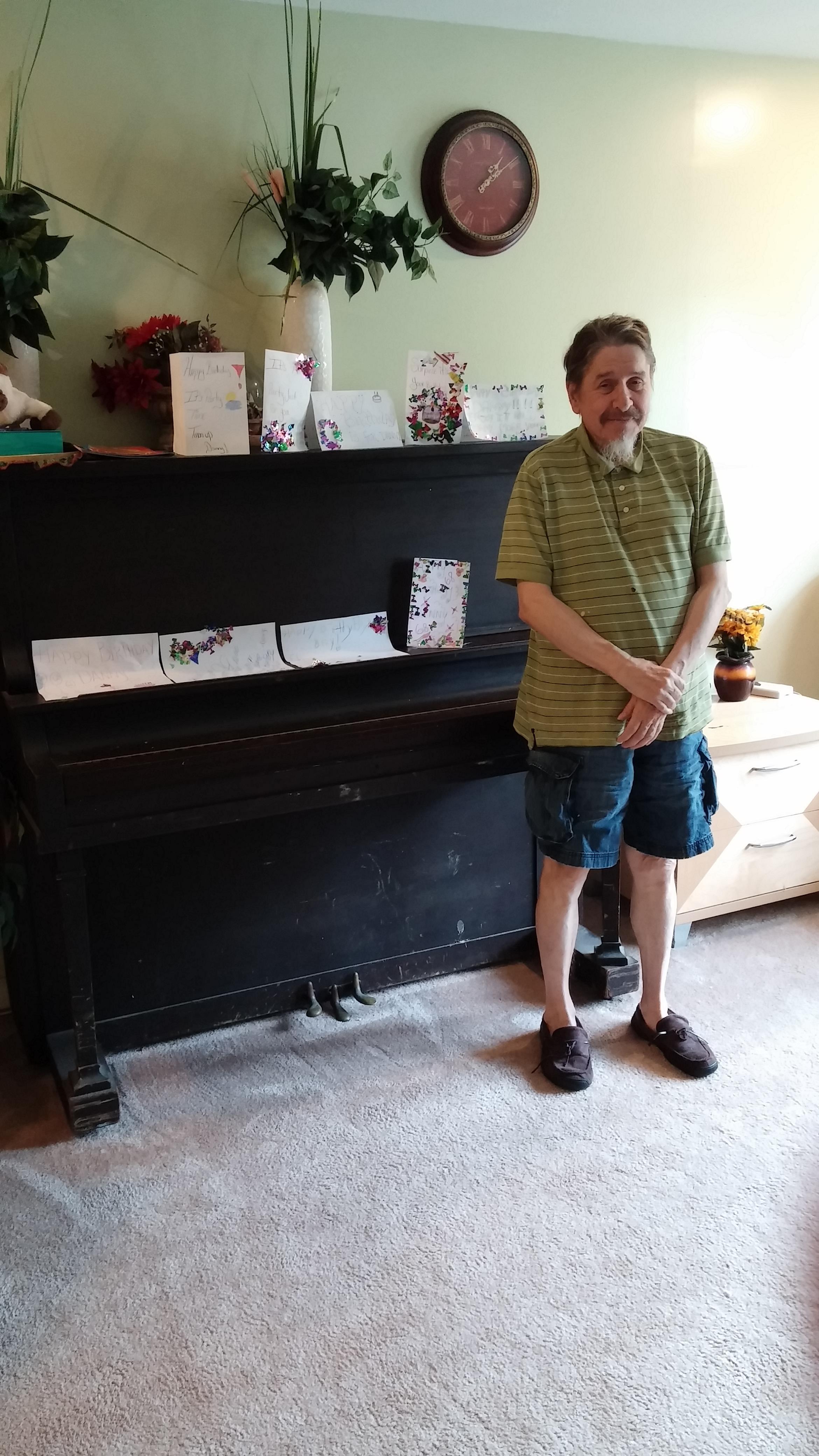 A man standing next to a piano