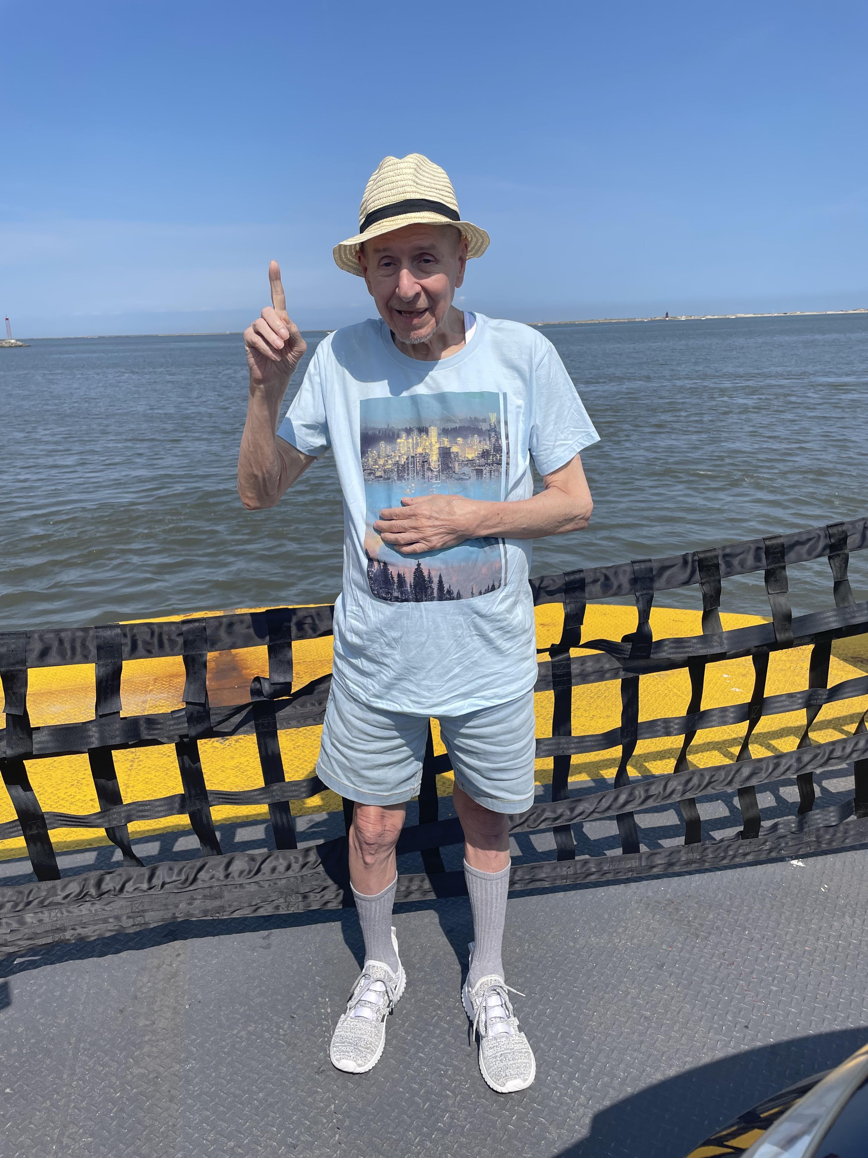 A man standing on a dock with a hand up