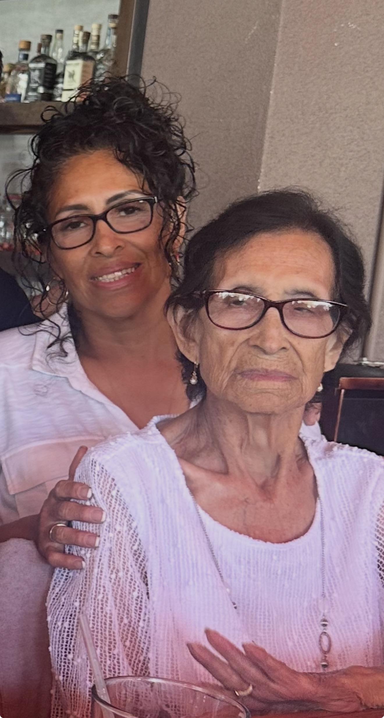 A woman and a woman posing for a picture