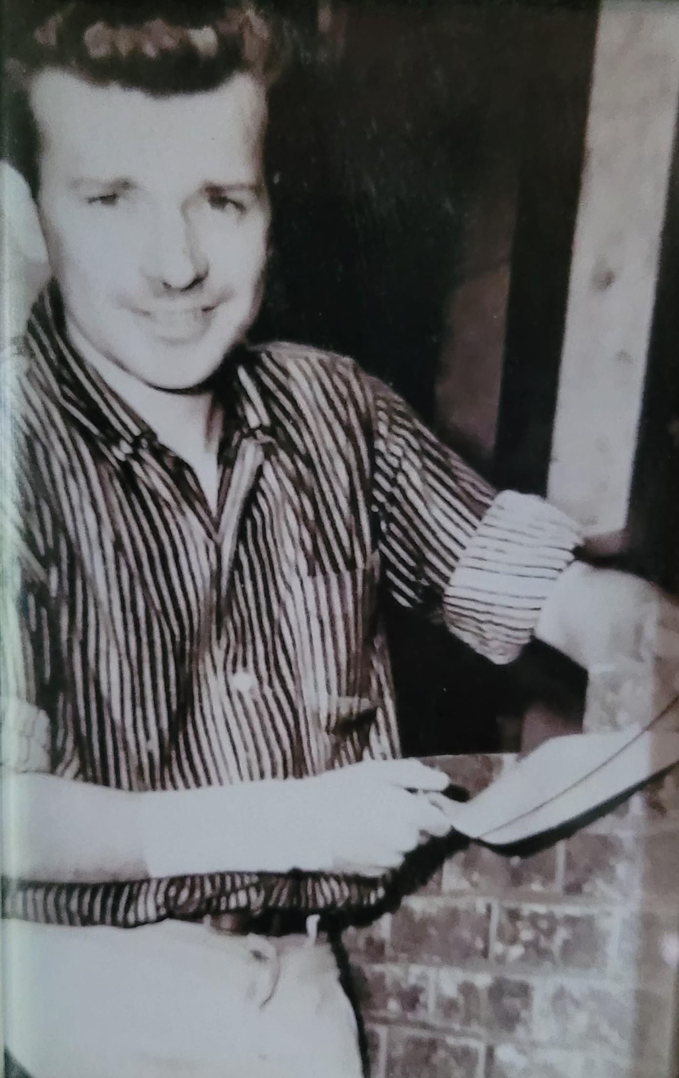 A man smiling with a paper