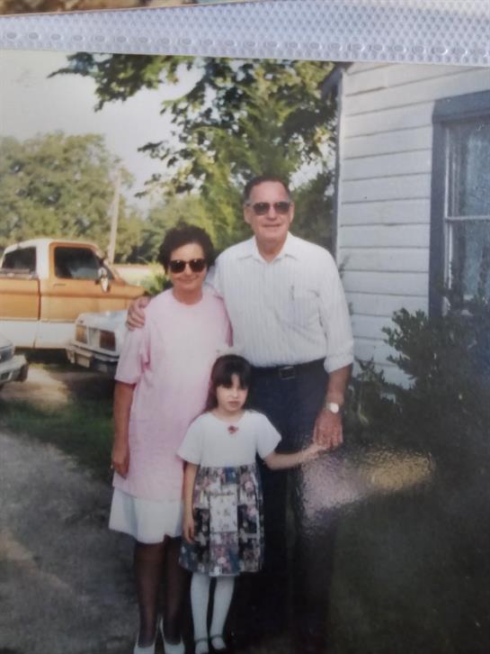A group of people standing outside a house