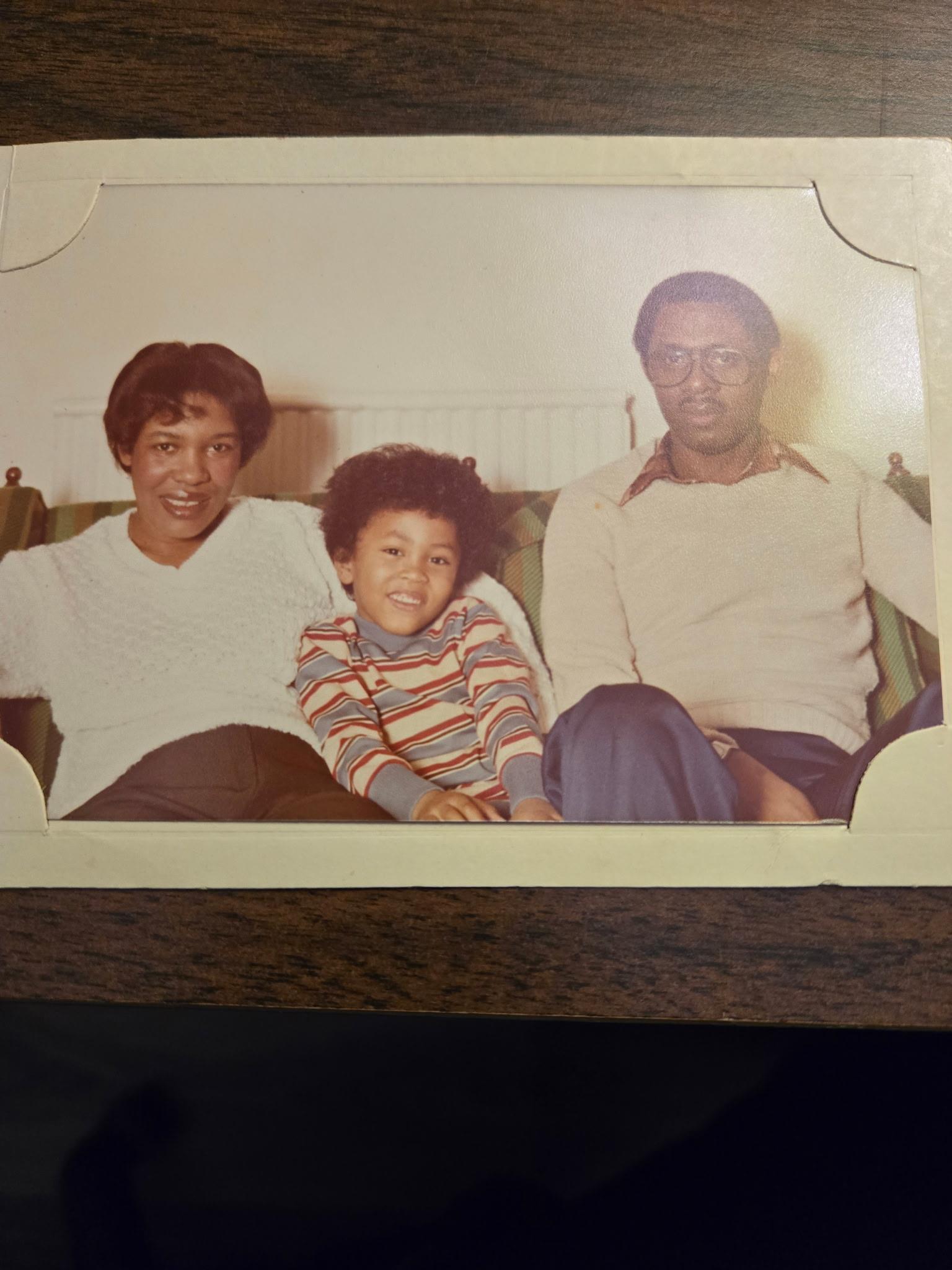 A family photo of a man and a woman and a boy