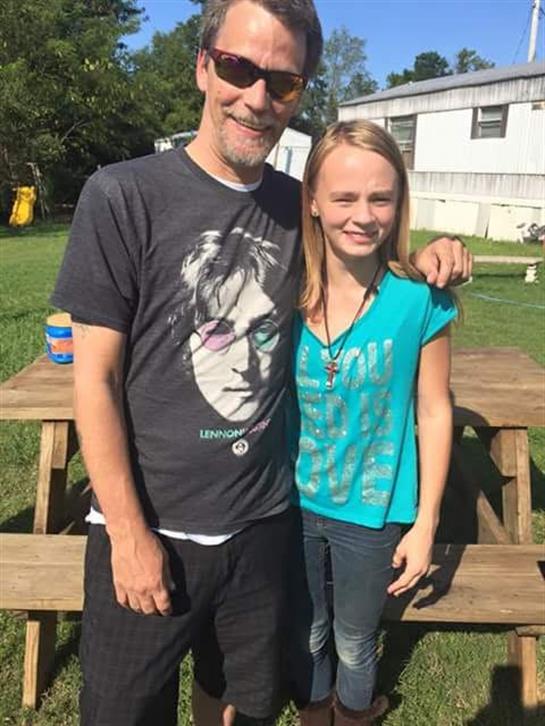 A man and a girl posing for a picture