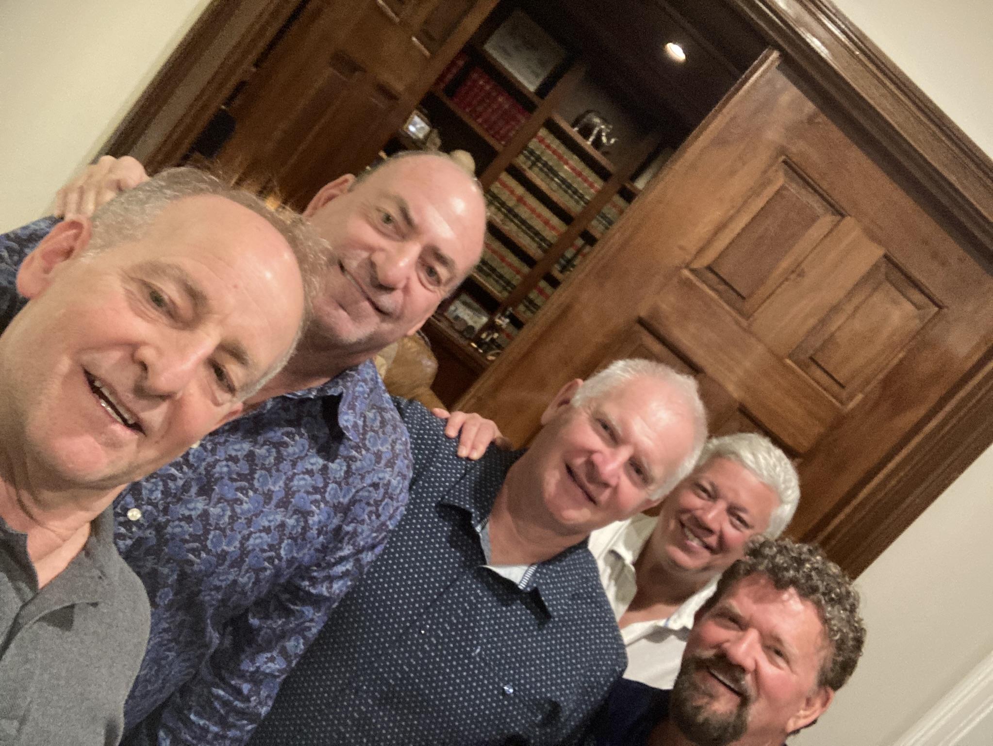 A group of men posing for a photo