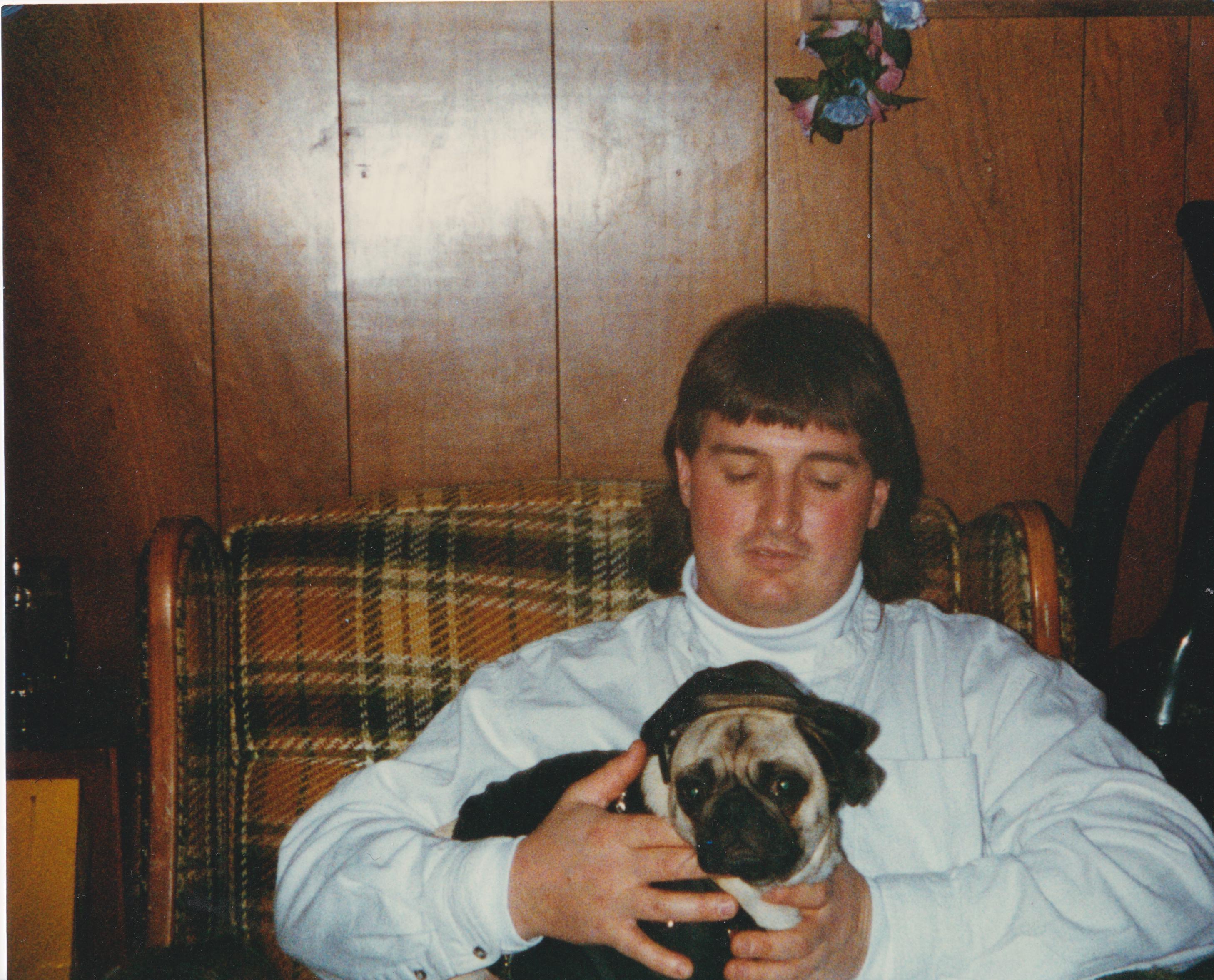 A man holding a dog