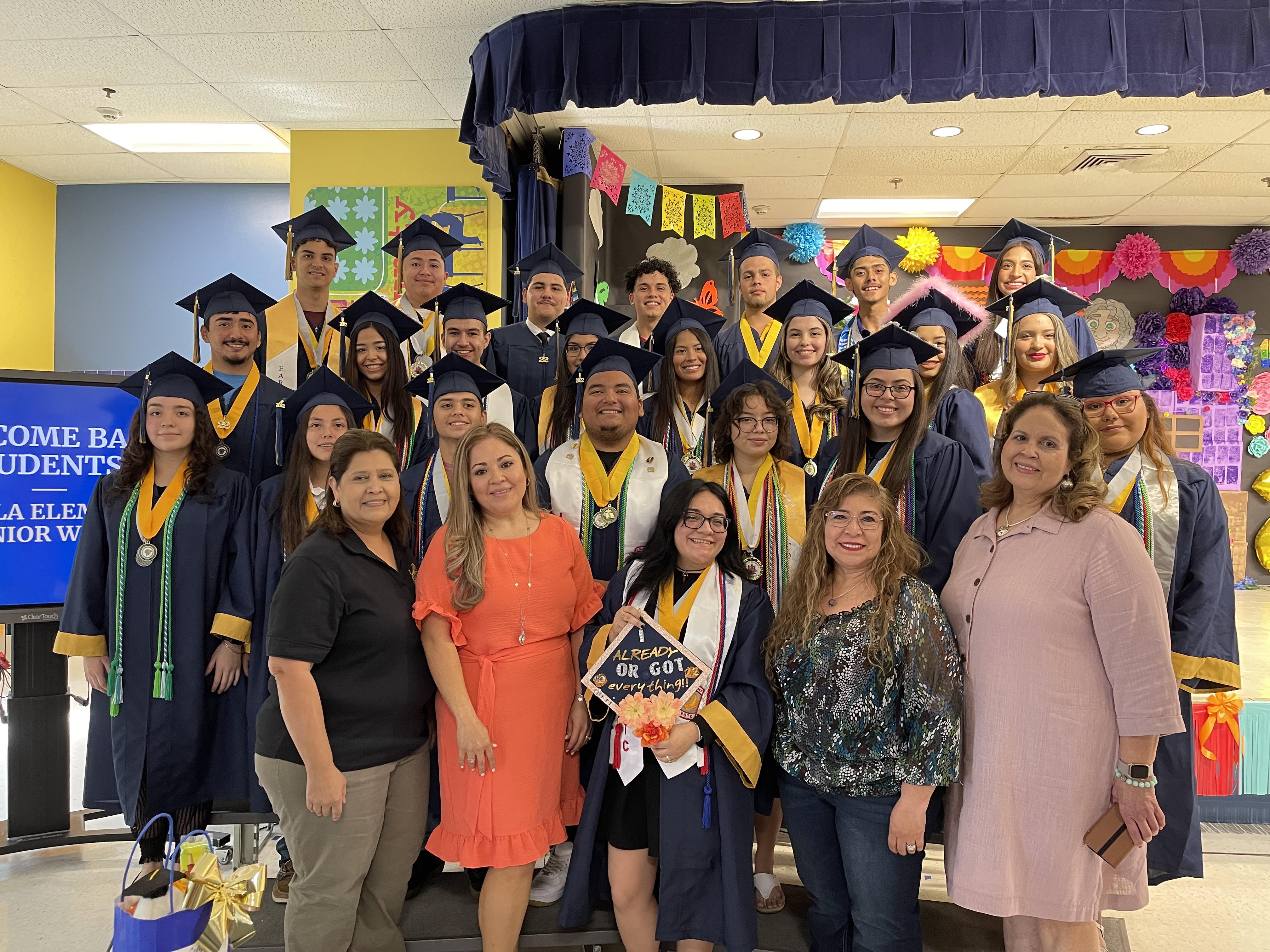 A group of people in graduation gowns and caps