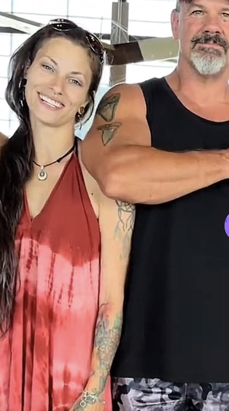A man and woman posing for a picture