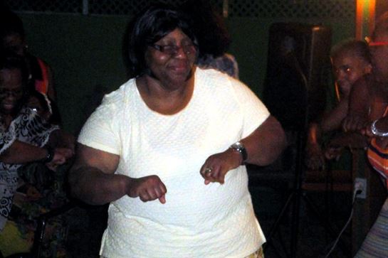 A woman dancing in a dark room