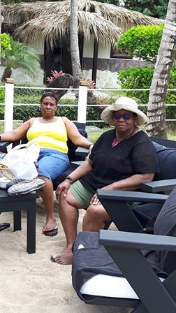 Two women sitting on chairs outside