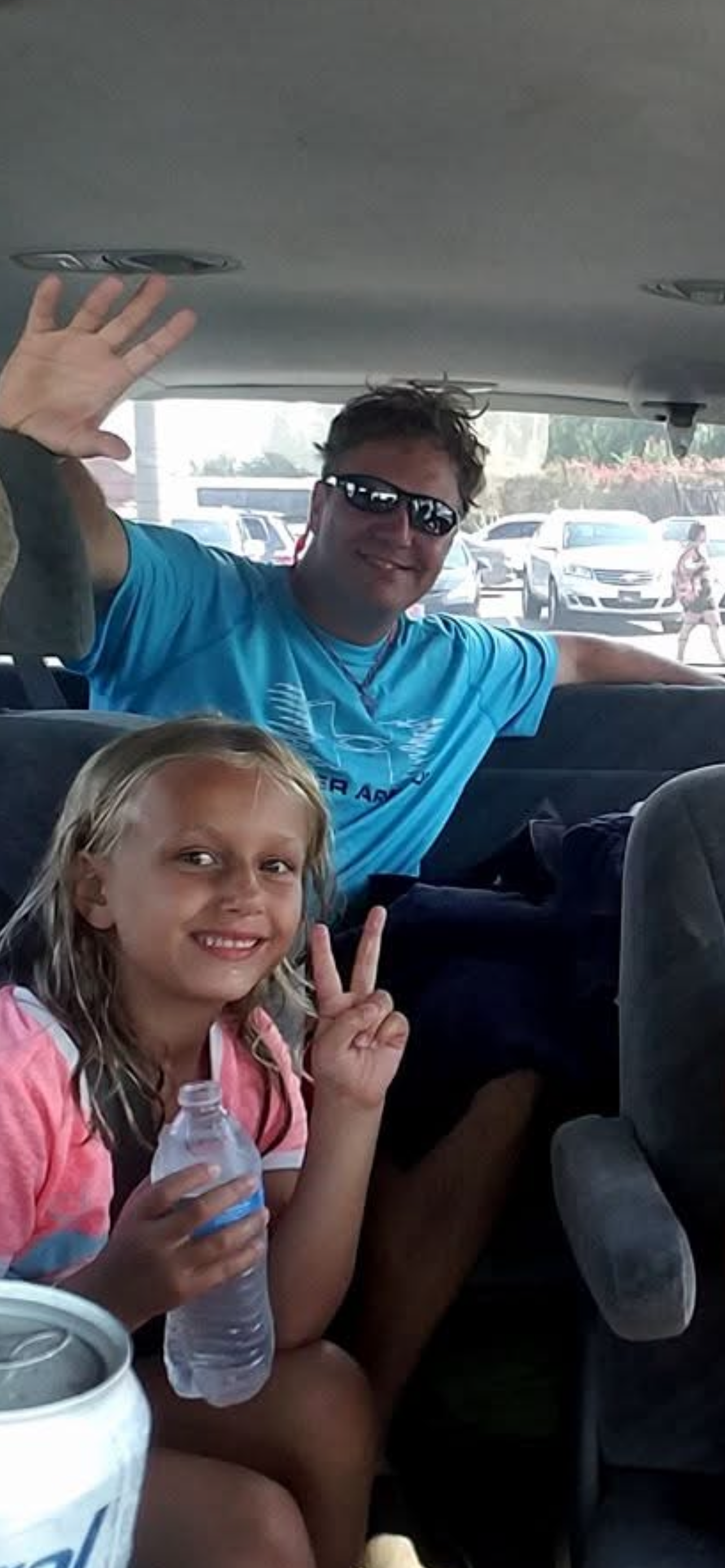 A man and a girl in a car