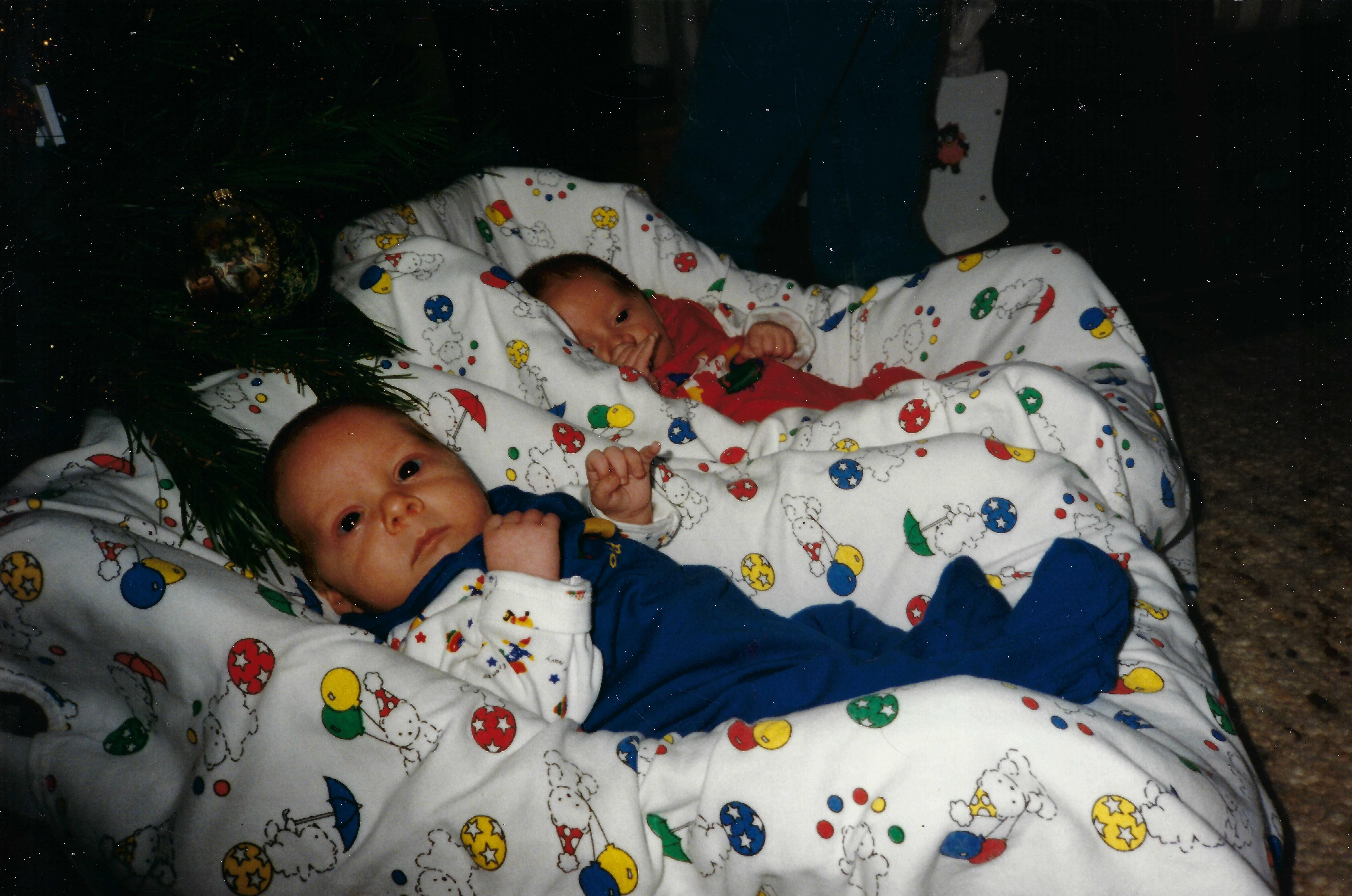 Two babies lying in blankets