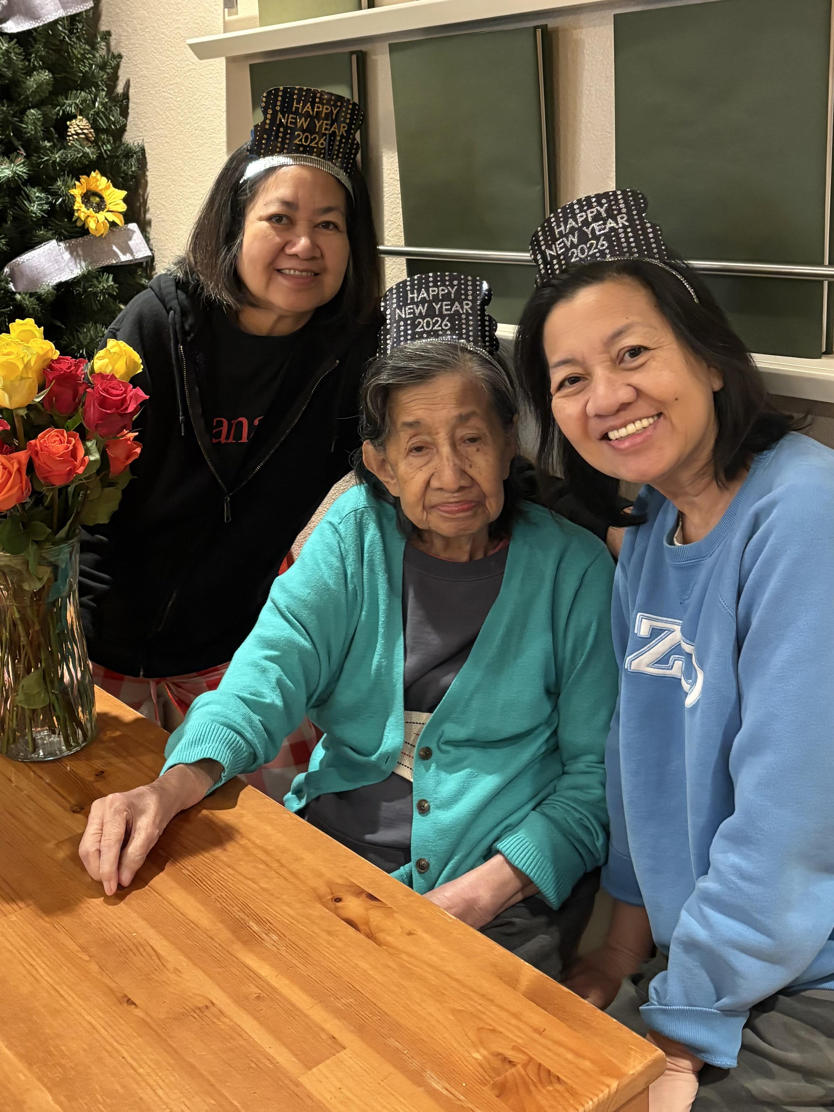 A group of women sitting at a table with flowers