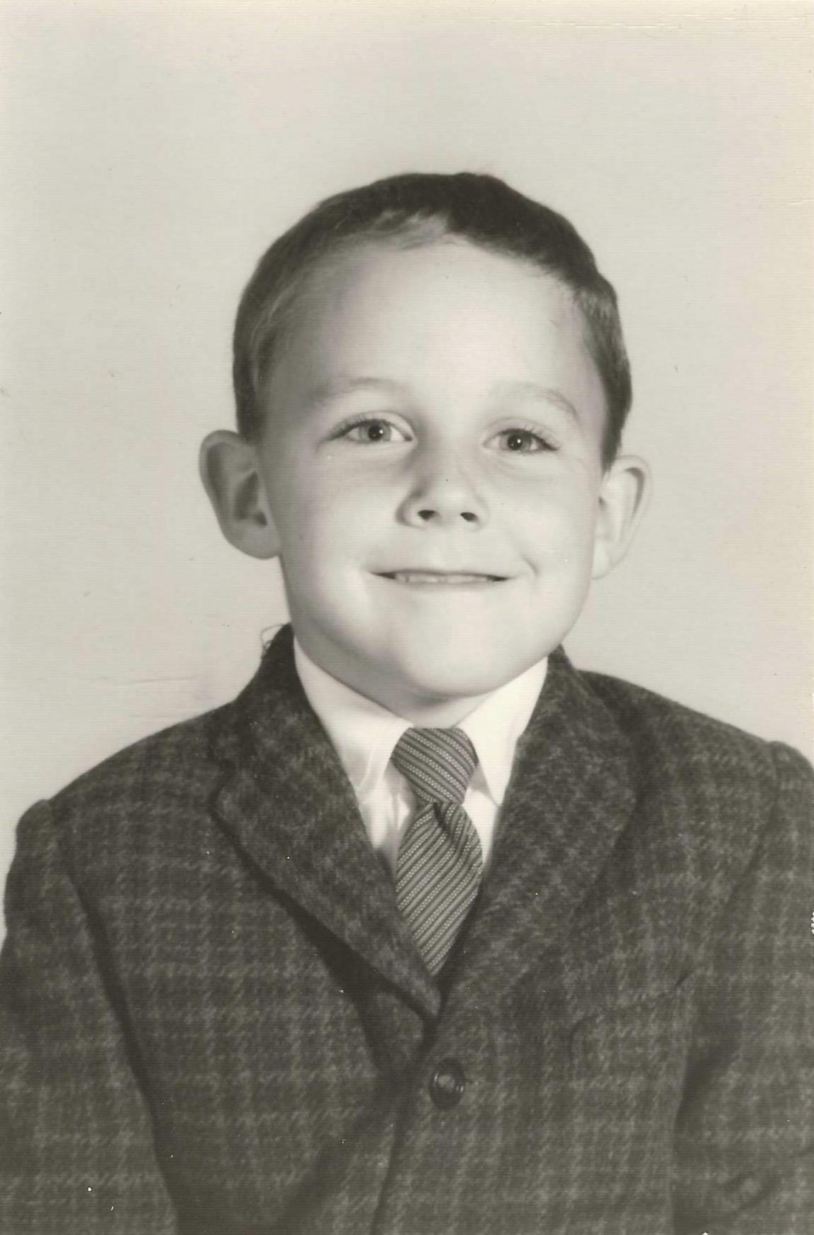 A young boy in a suit