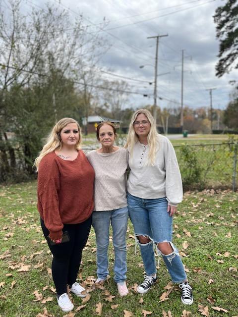 A group of women standing in a yard