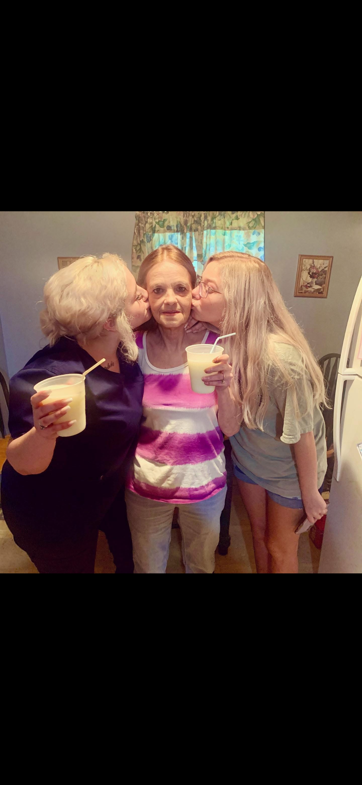 A group of women kissing a woman