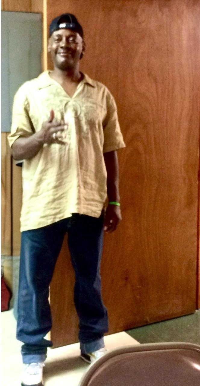A man standing in front of a wooden door