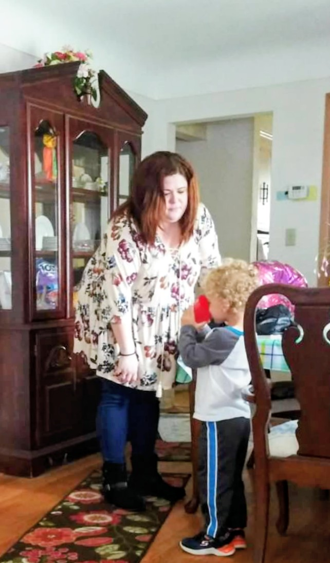 A woman standing next to a child