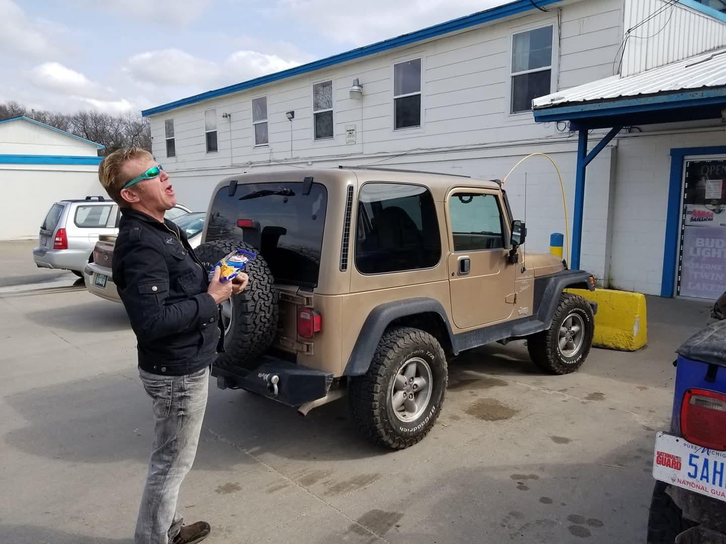 A man standing next to a car