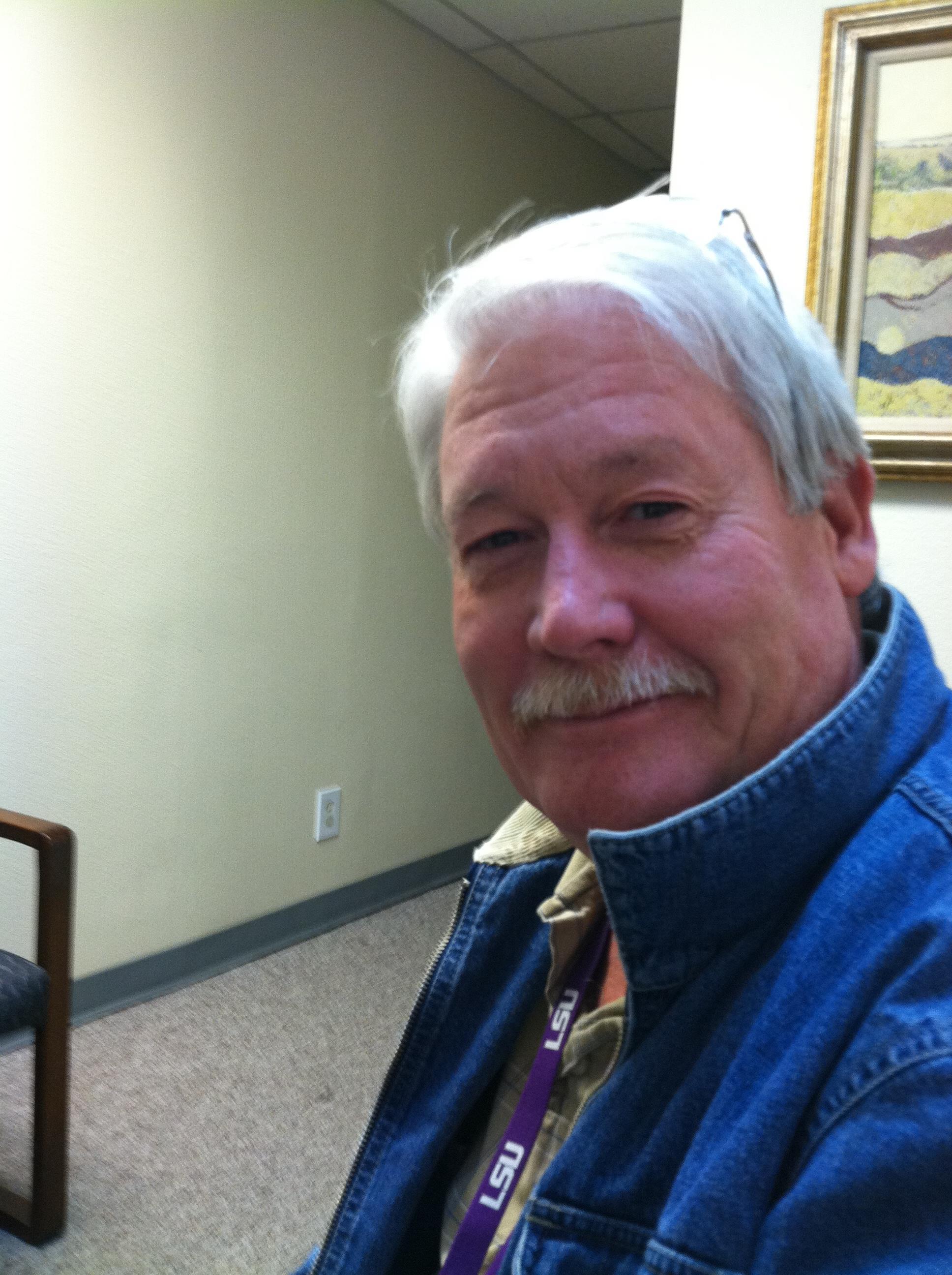 A man with white hair and a mustache