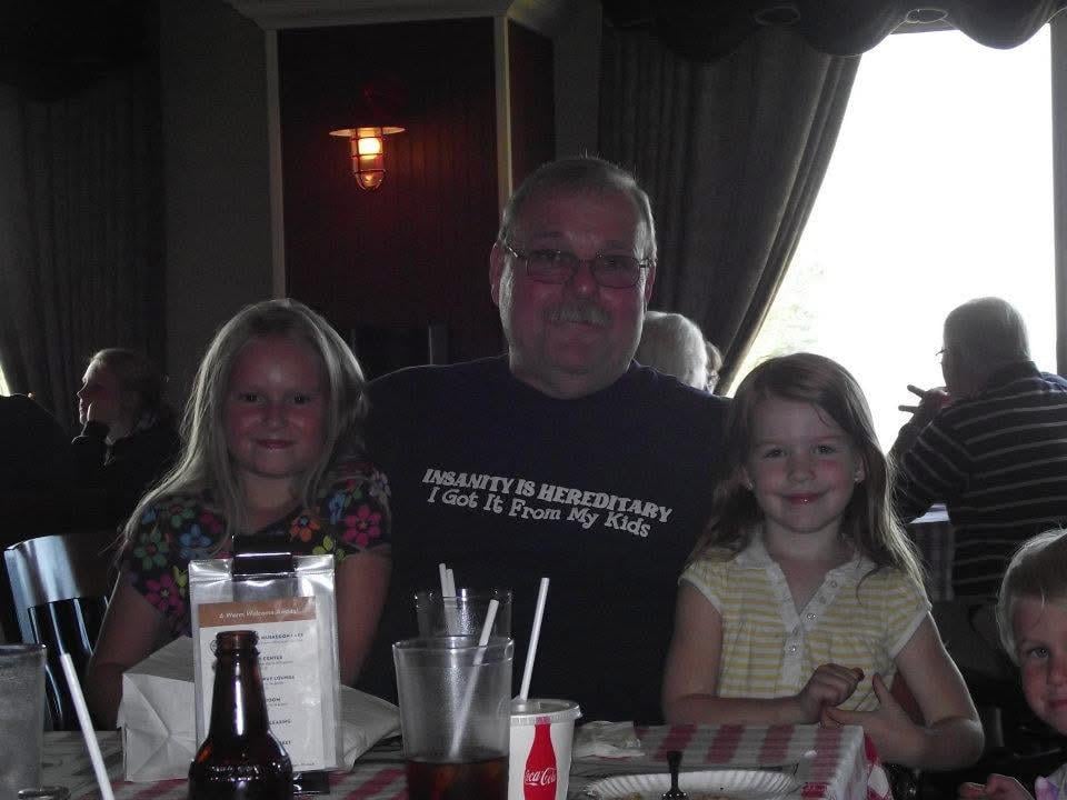 A man and two children sitting at a table