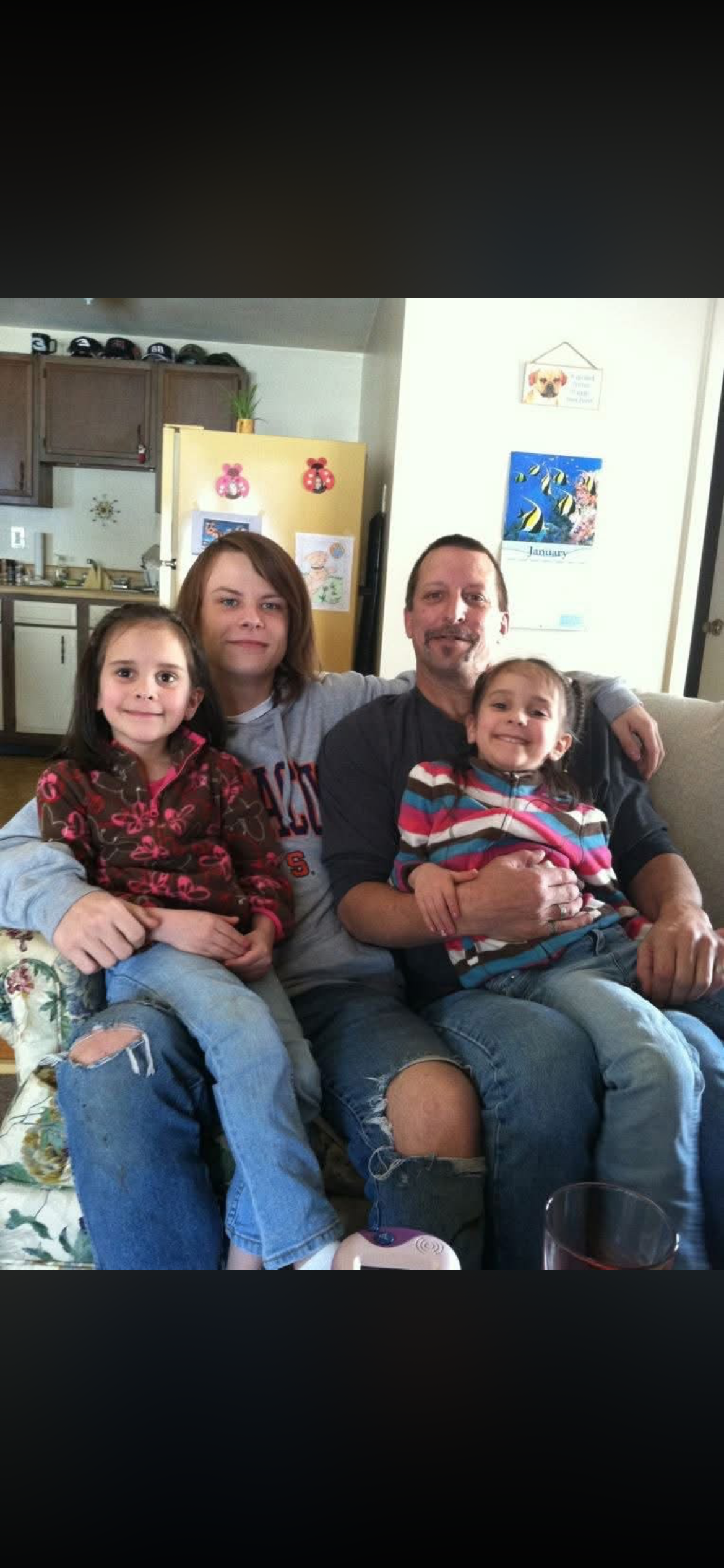 A family sitting on a couch