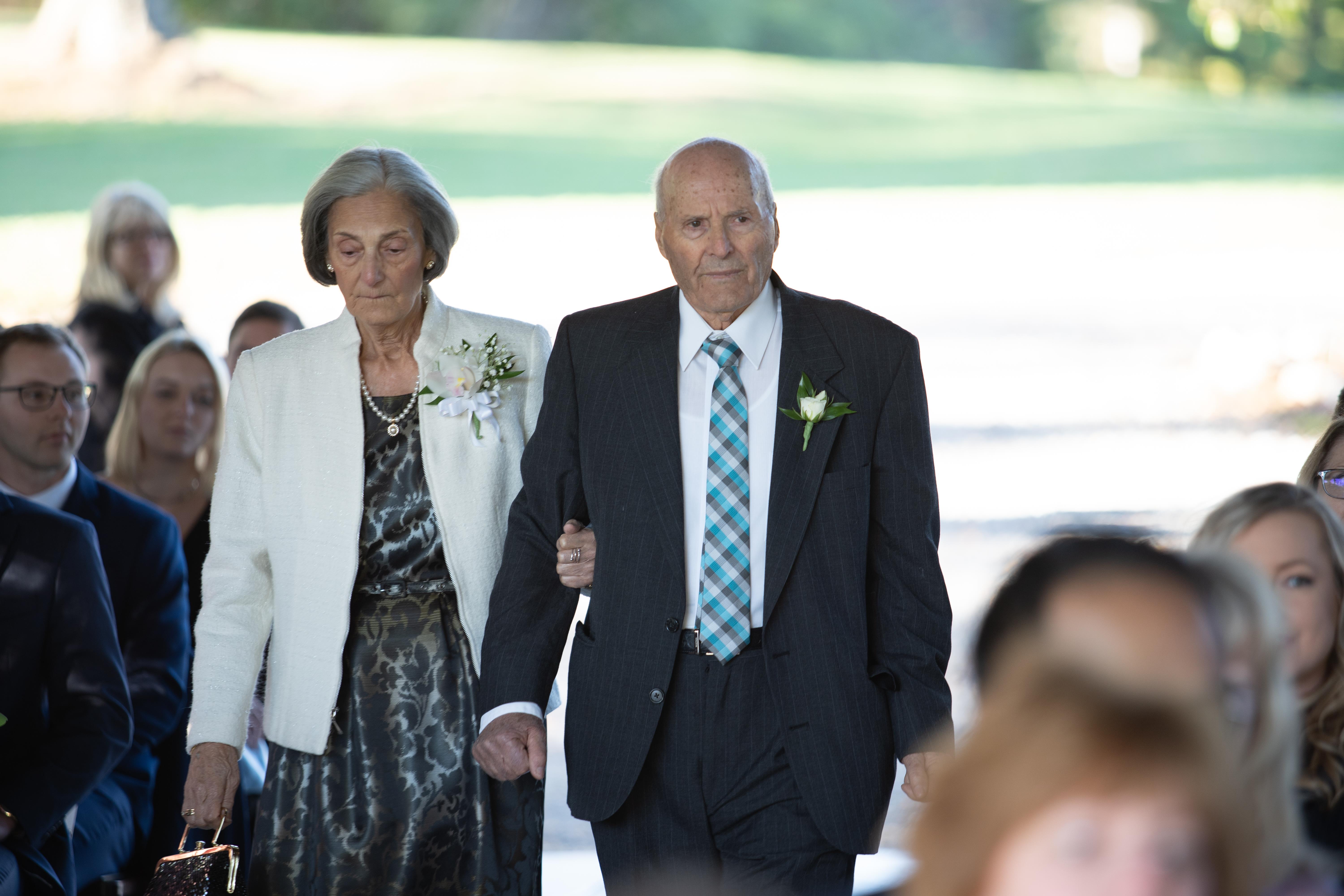 A man and woman walking down the aisle