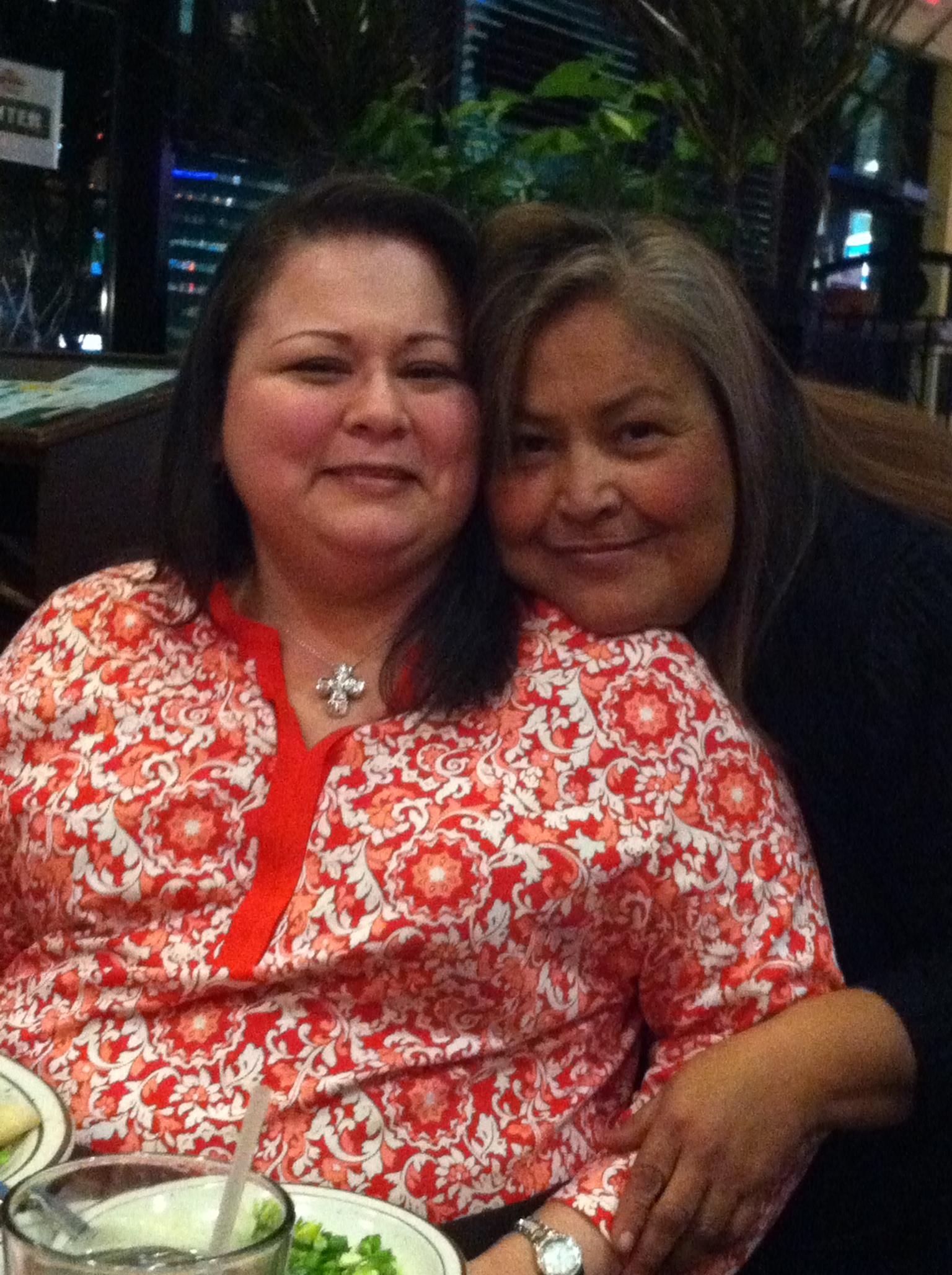 Two women sitting together smiling