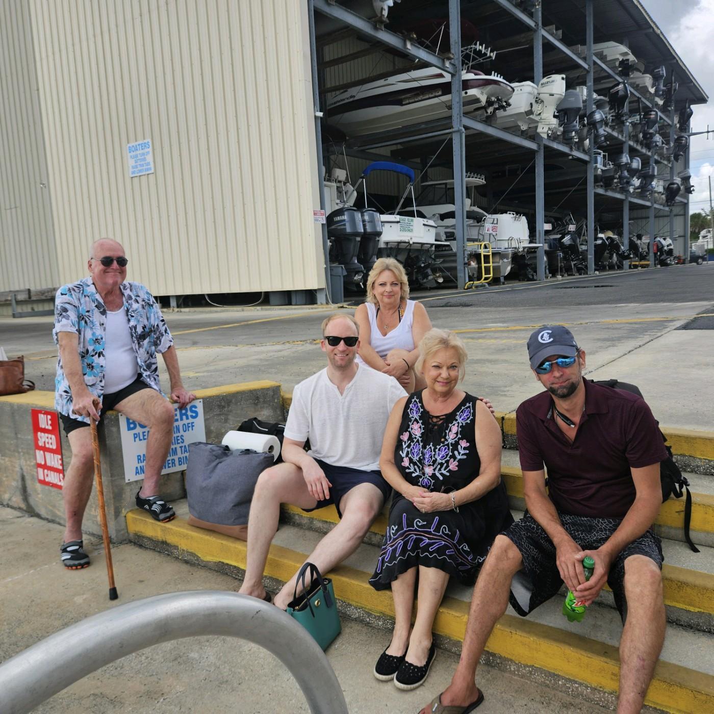 A group of people sitting on stairs outside a building