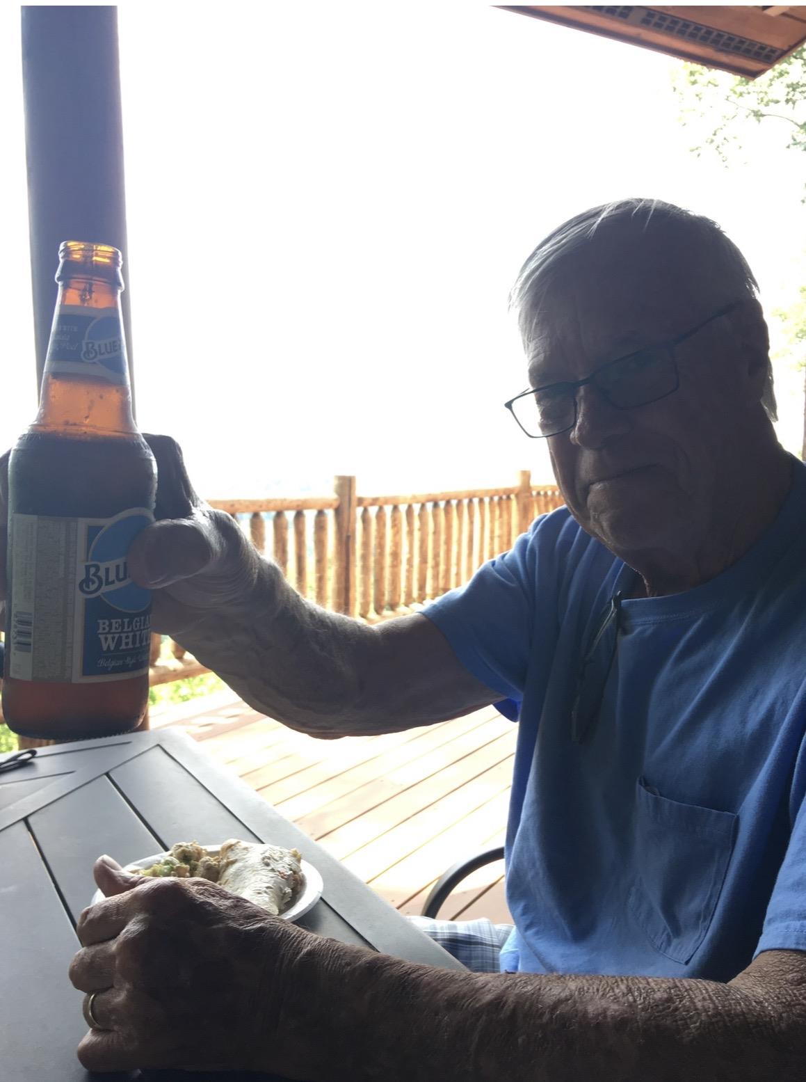 A man holding a bottle of beer