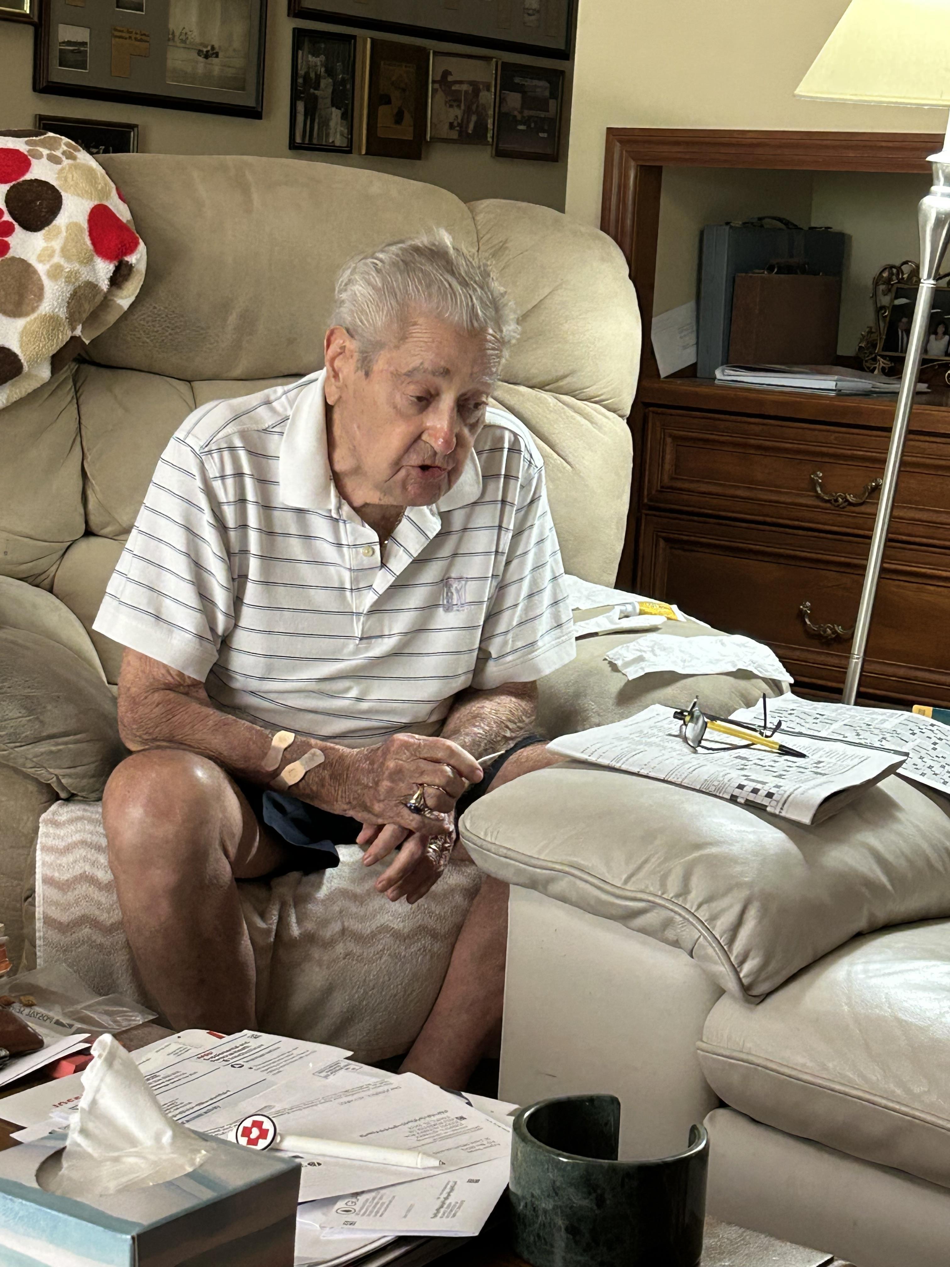 An old man sitting on a couch