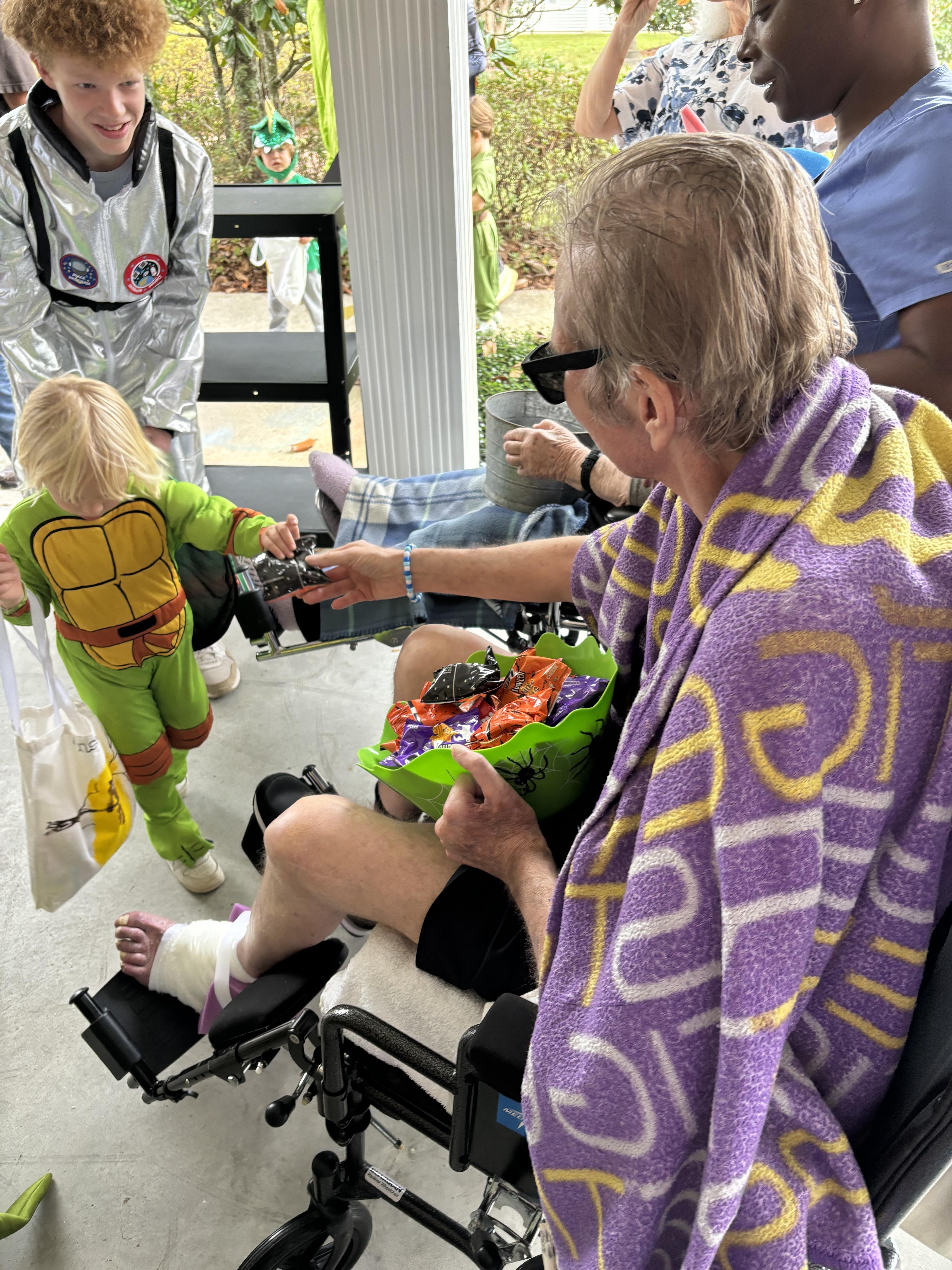 A man in a wheelchair with a child in a garment