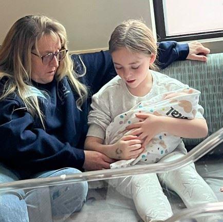 A woman holding a baby