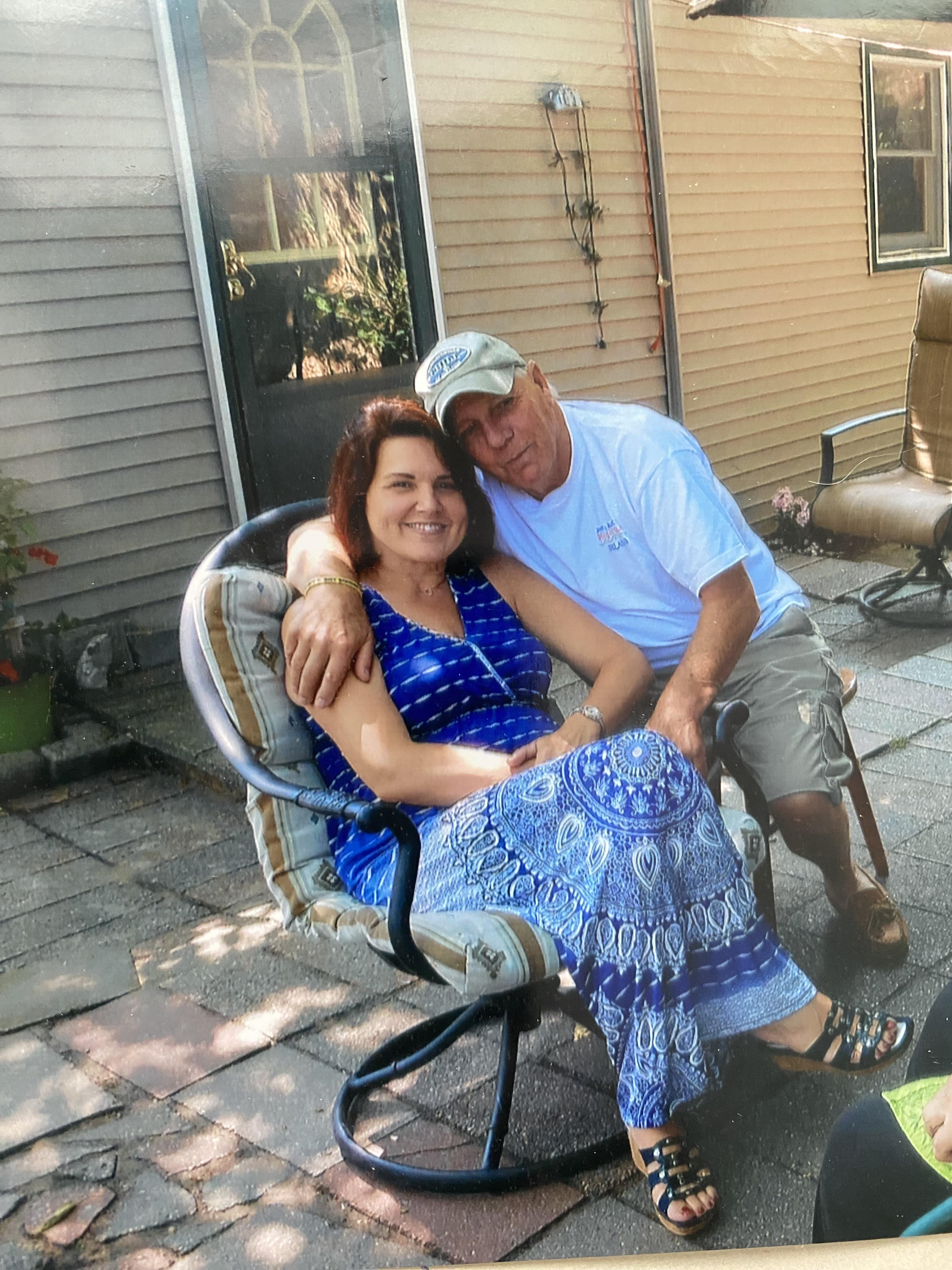 A man and woman sitting in a chair