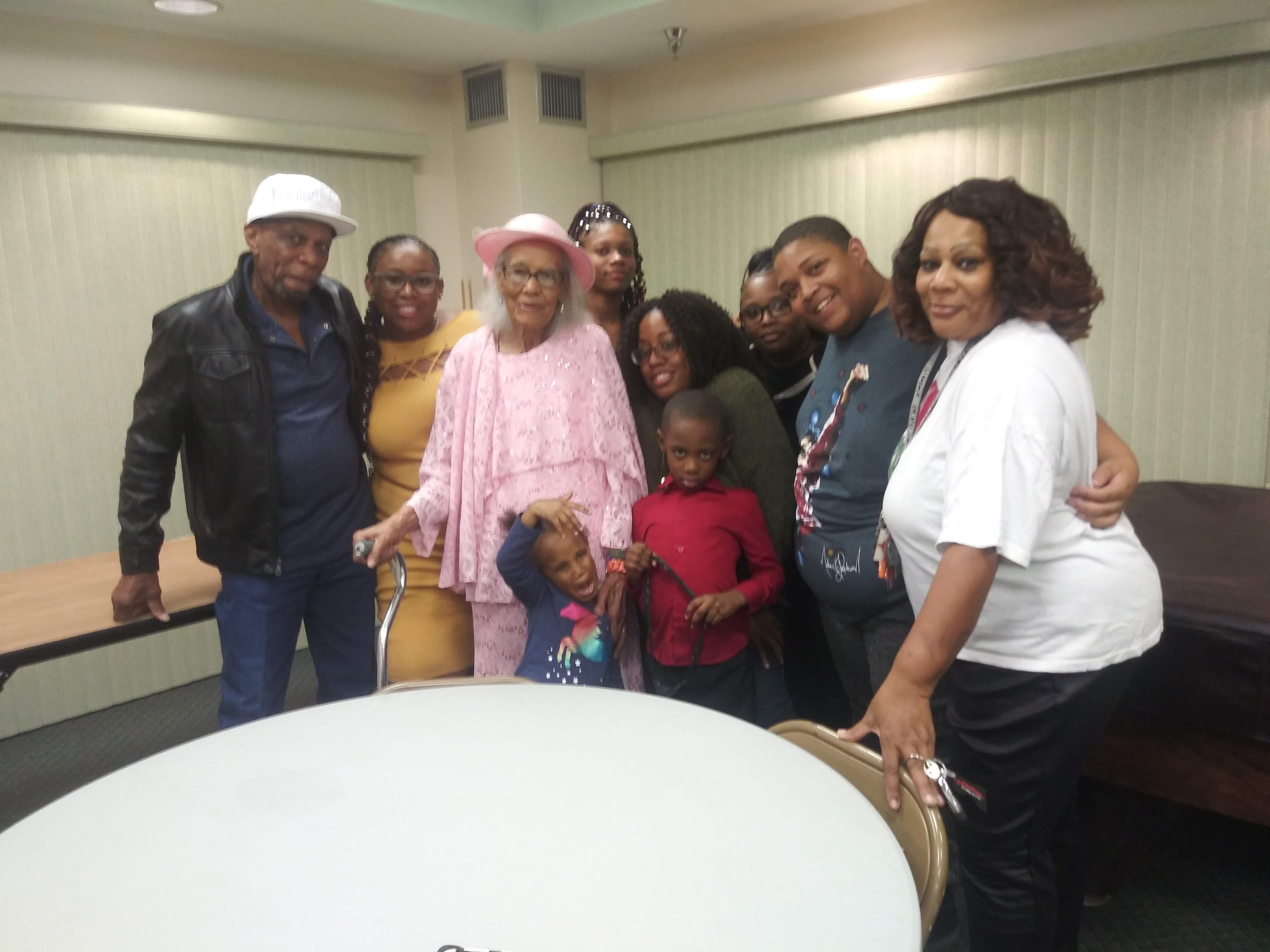 A group of people standing around a table