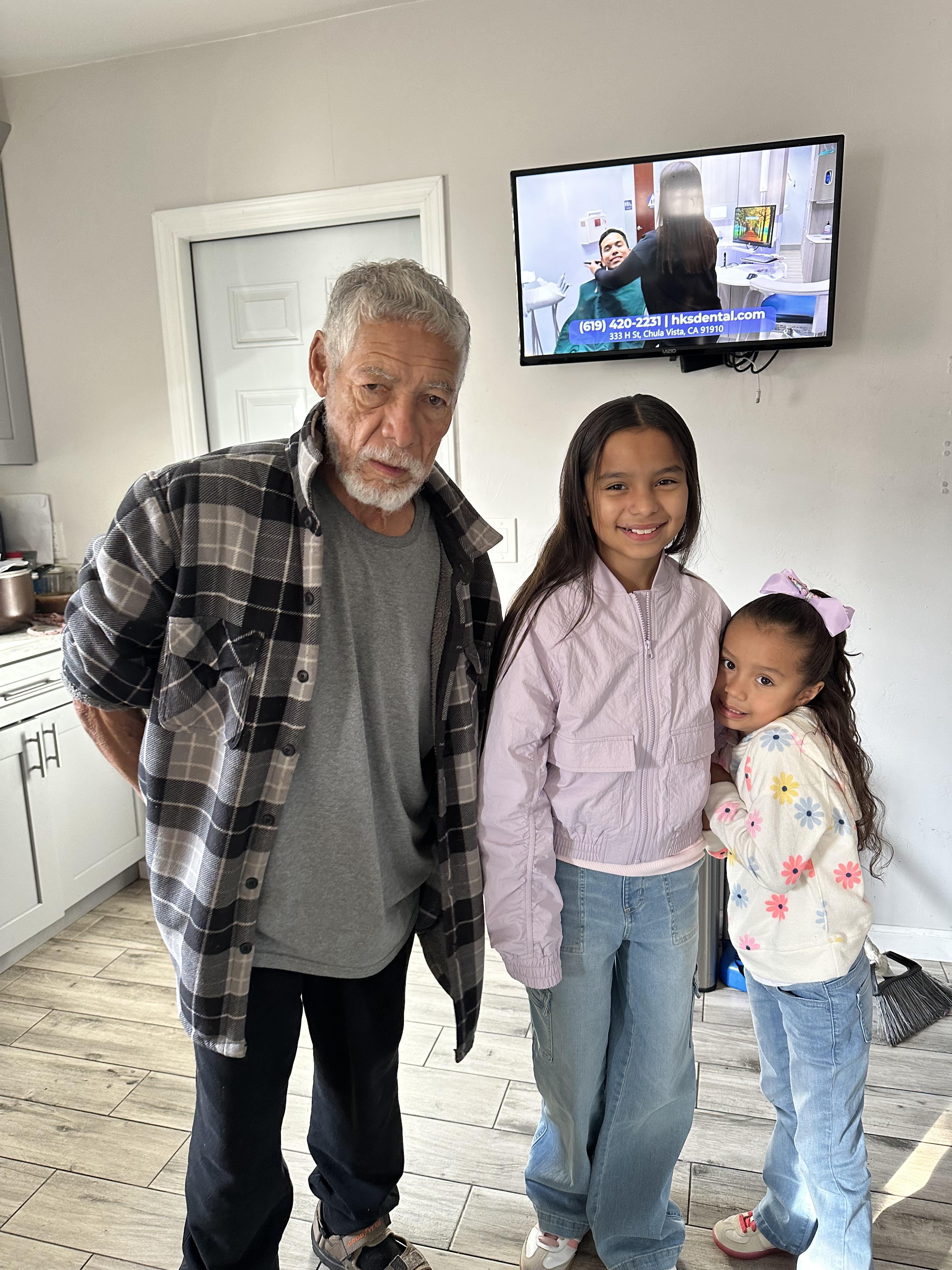 A man and two girls posing for a picture