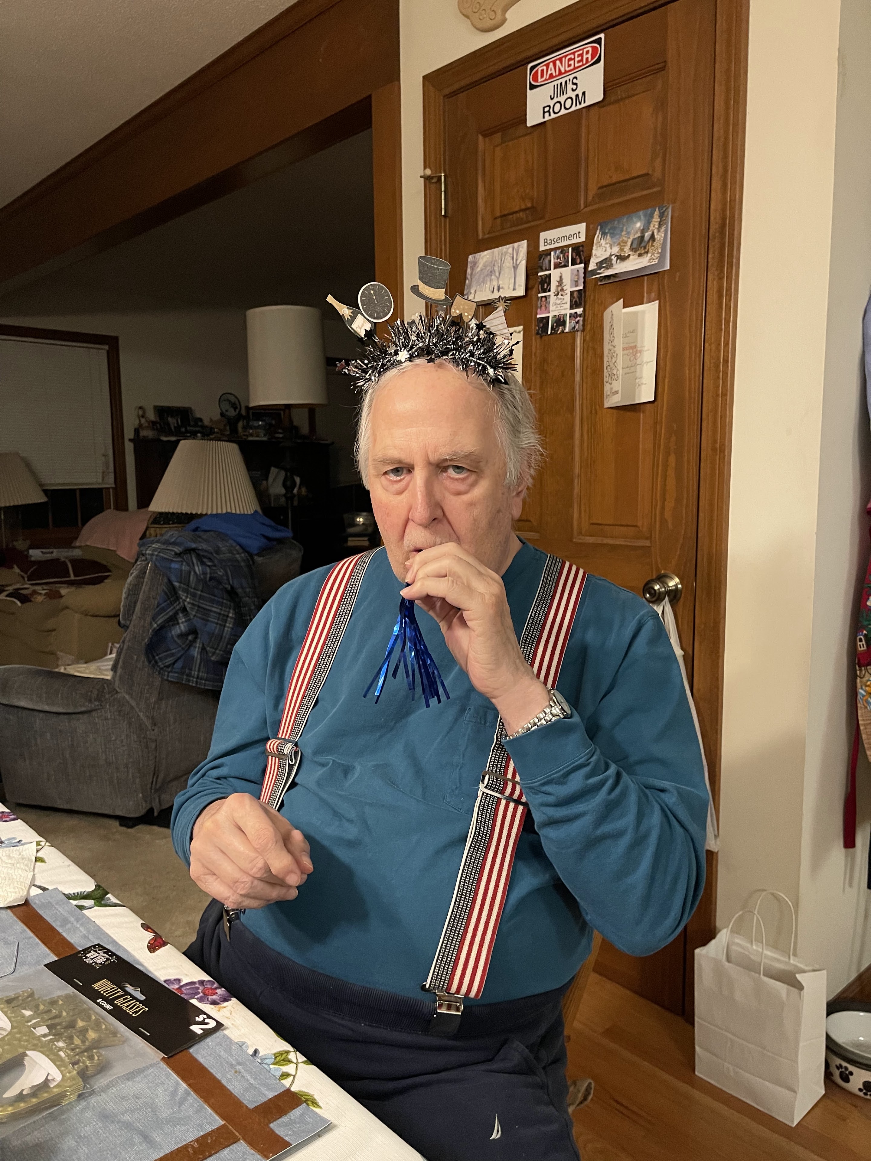 A man wearing suspenders and a hat