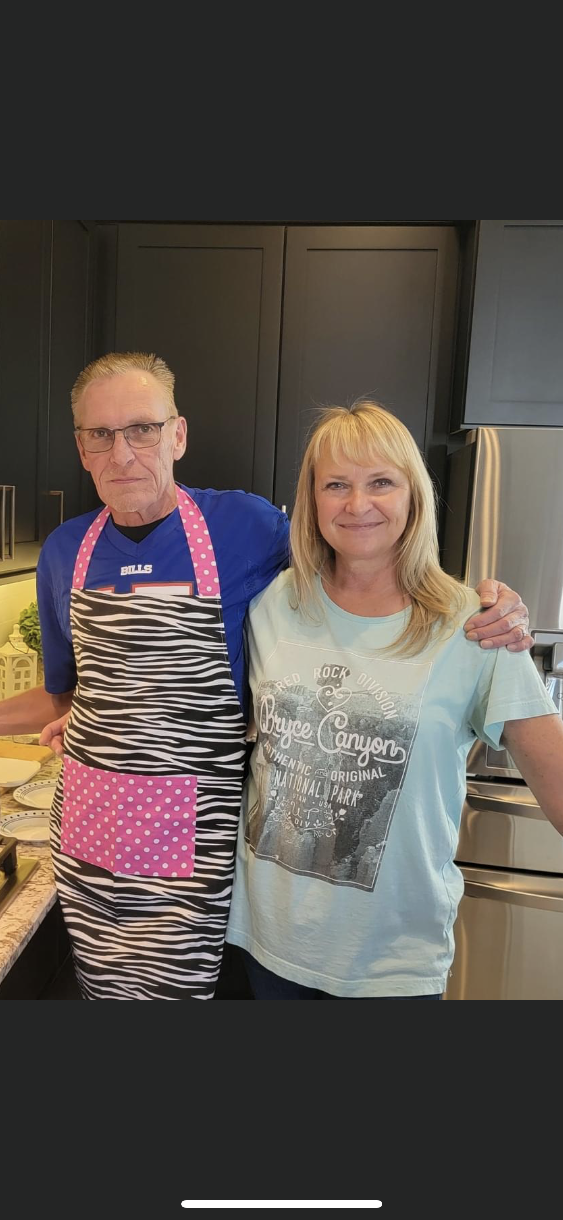 A man and woman standing in a kitchen
