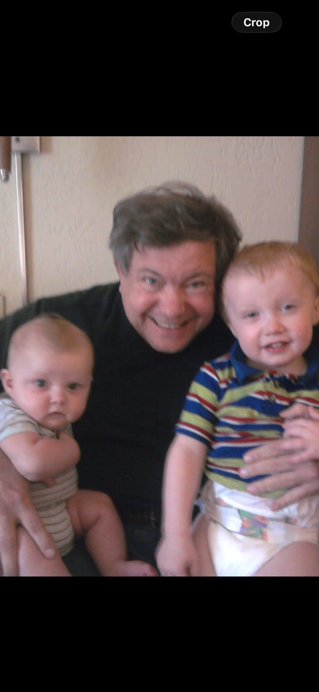 A man holding two babies