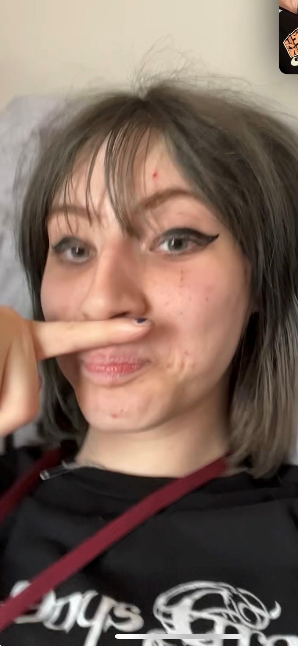 A woman holding her finger to her mouth