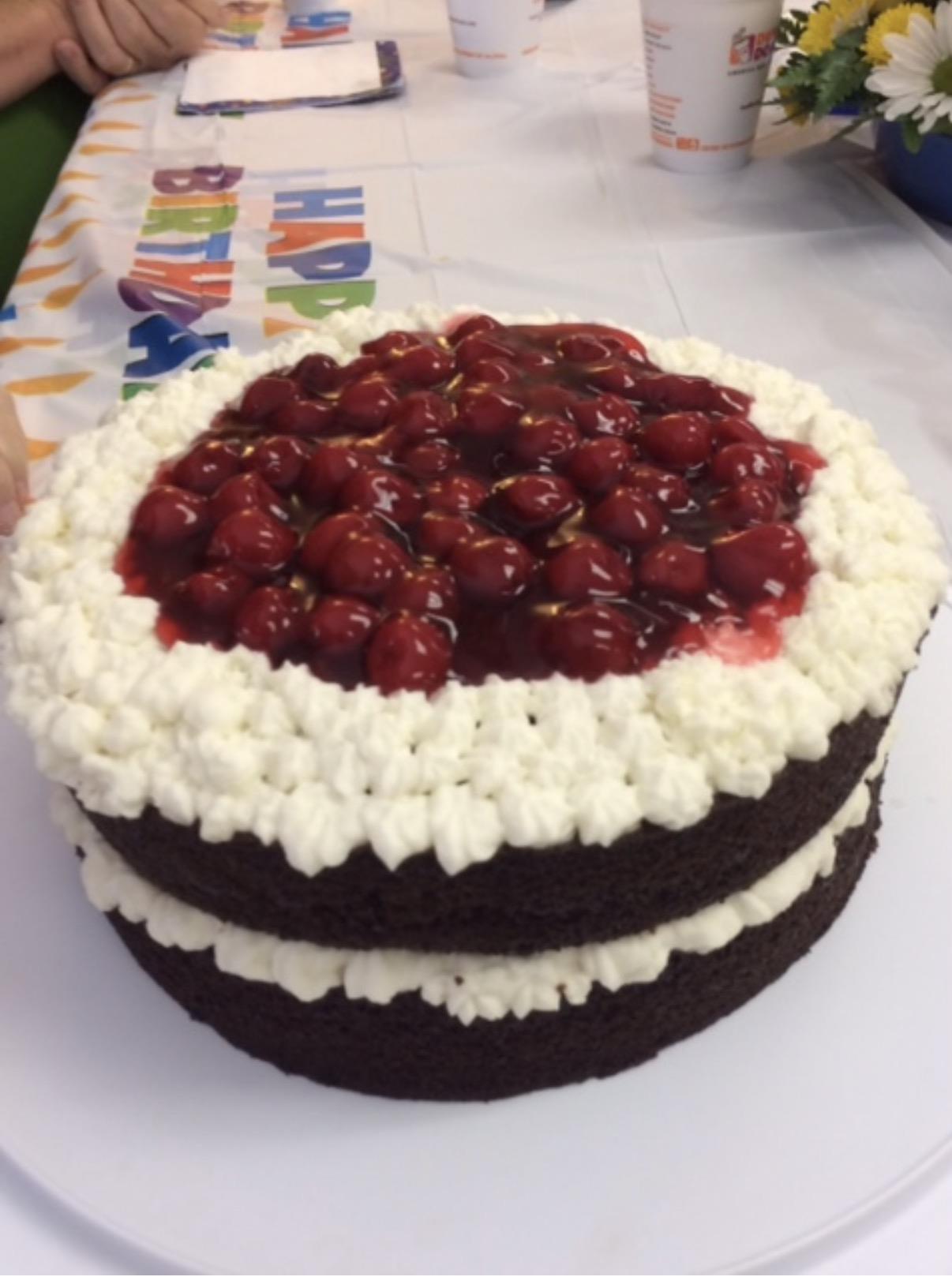 A cake with cherries on top